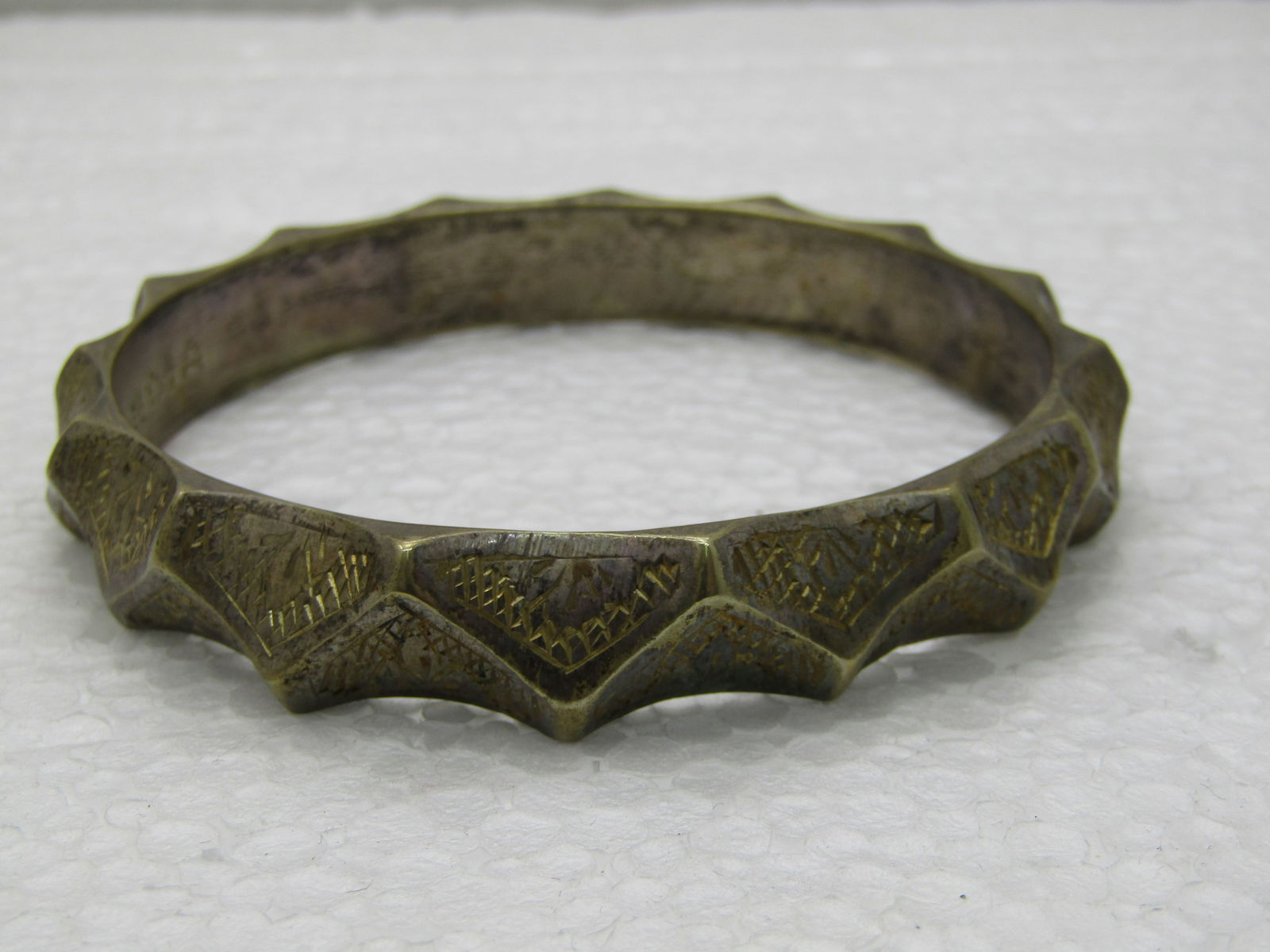 Vintage Curved Notched India Bangle Bracelet, 8.25", 1960's: Vintage Curved Notched India Bangle Bracelet, 8.25", 1960's, Silver tone base with gold finish over with engraved/stamped design. 11mm wide. Heavy bracelet, Unisex. Opening is 2.75". There is finish w