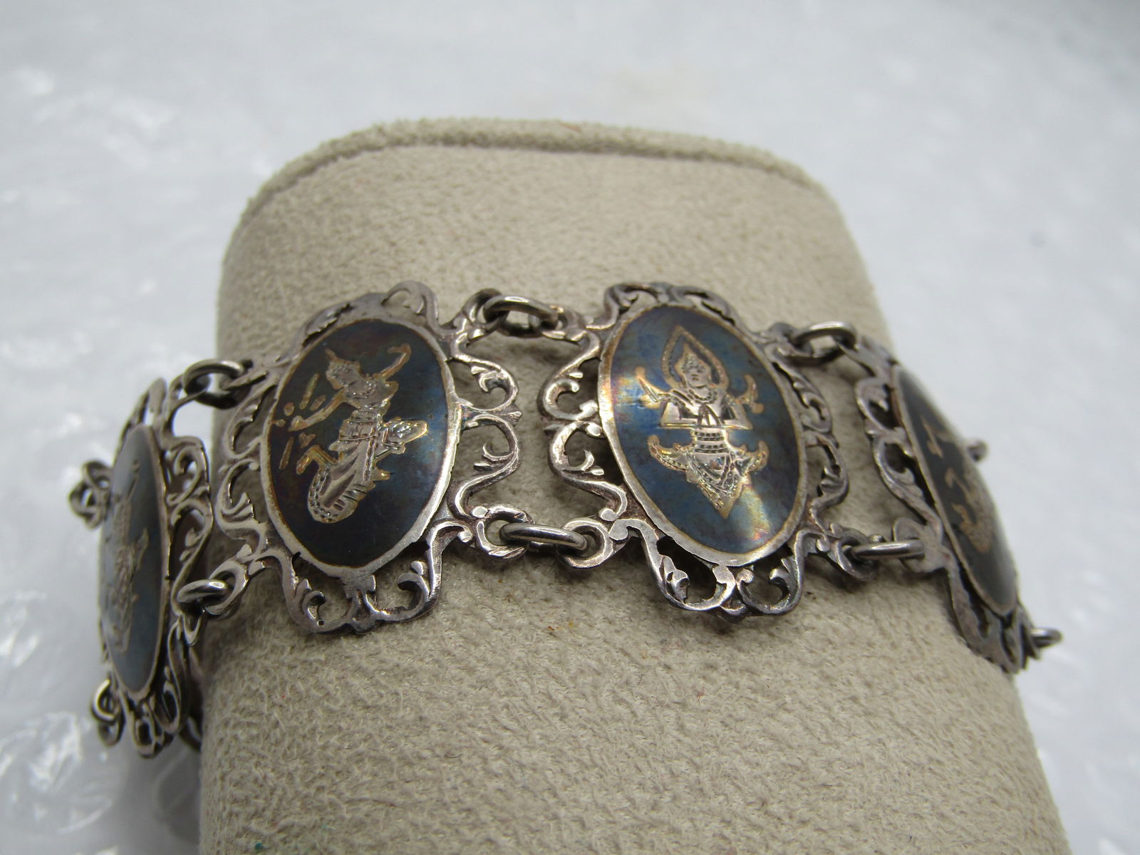 Vintage Sterling Fiigree Siam Bracelet, 1940's-1950's, 7": Vintage Sterling Fiigree Siam Bracelet, 1940's-1950's, 7". 1" wide with an oval black enameled slightly domed center with a goddess etched in every link and hen framed with a filigree design. The oval