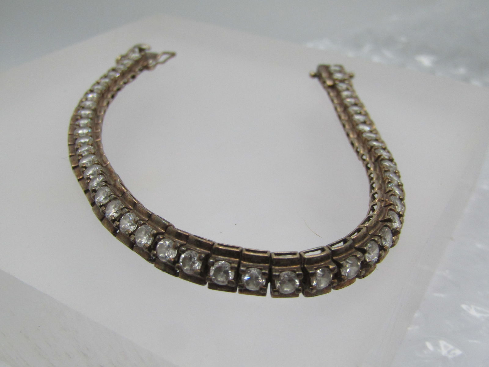 Vintage Sterling CZ Tennis Bracelet, 6mm, 7.25", Signed: Vintage Sterling CZ Tennis Bracelet, 6mm, 7.25", Signed R. This has a center of 3mm clear rhinestones set over a base wider than the stone. Each stone is like it's own link with a domed bar under the