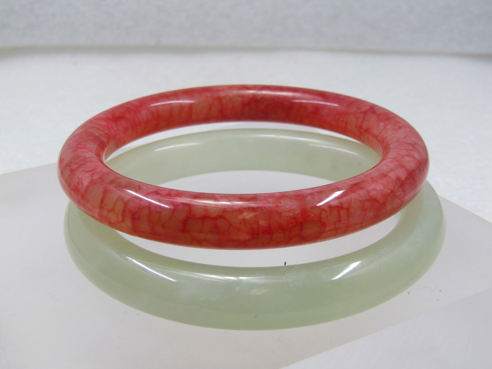 Vintage Pair Quartz Bangle Bracelets, 7", Orange and Green: Vintage Pair Quartz Bangle Bracelets, 7", Orange and Green. They are round and appx. 10mm wide. The opening isappx. 2.5". One is an orange colored that appears to be died, the other is a pale
