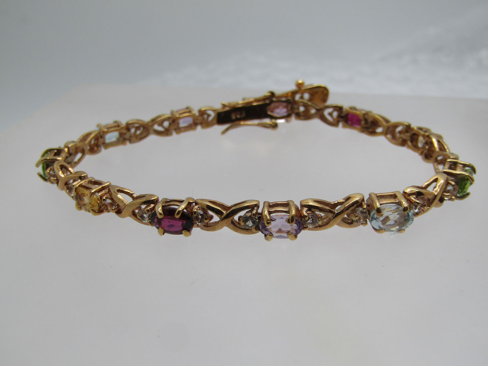 Vintage Vermeil Gemstone Tennis Bracelet, Signed FAS, 7.5": Vintage Vermeil Gemstone Tennis Bracelet, Signed FAS, 7.5". This has an X O (oval) design with oval gemstones in amethyst, garnet, topaz, citrine, peridot. The stones are appx. 5.5mm by 4mm. Between e