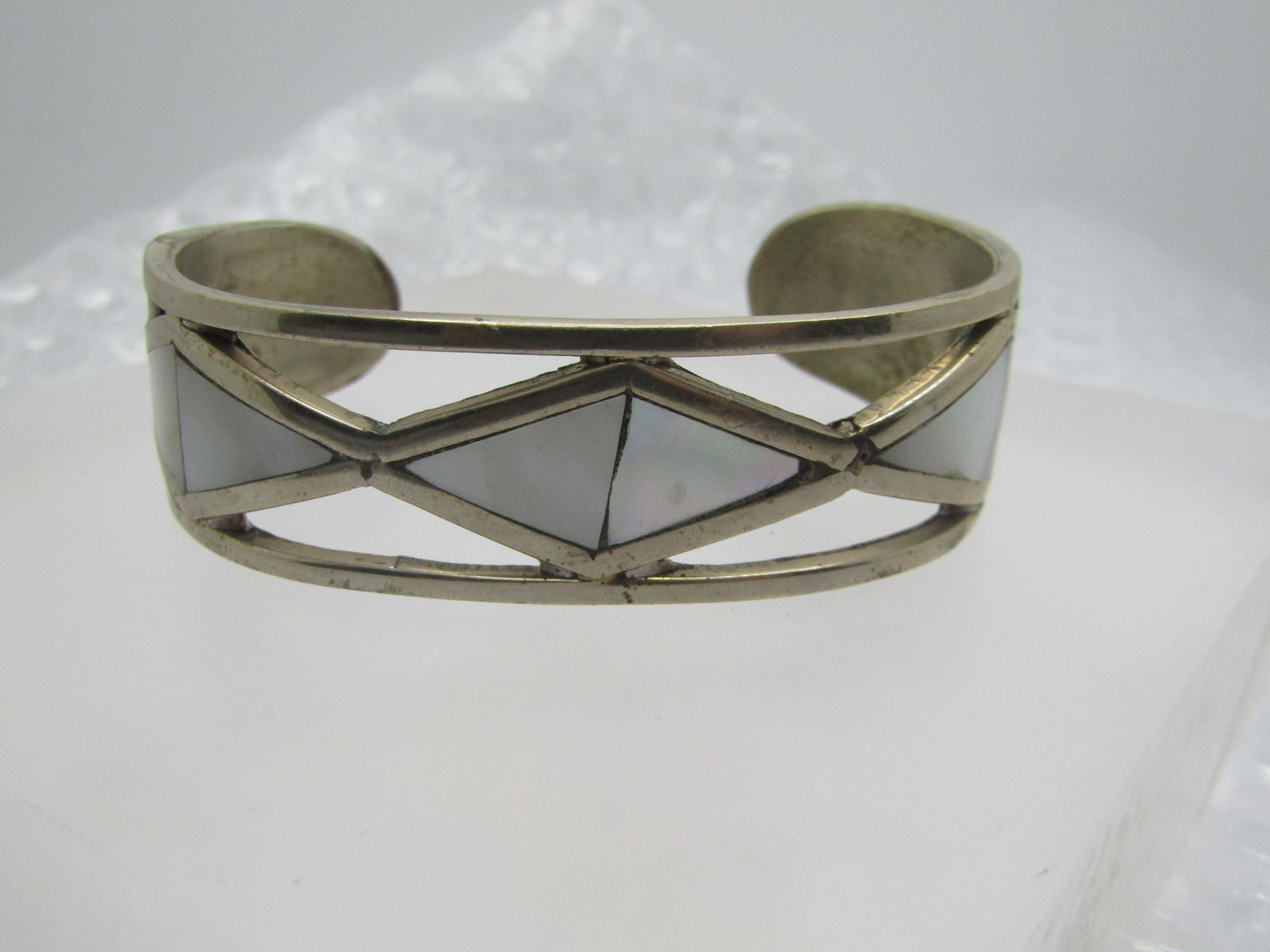 Vintage Inlaid Mother-of-Pearl and Abalone Geometric Cuff Bracelet, 6.5": Vintage Inlaid Mother-of-Pearl & Abalone Geometric Cuff Bracelet, 6.5". It is 3/4" wide at top center and appx. 5/8" at the back rounded ends of the cuff. It has two sections of inlaid white