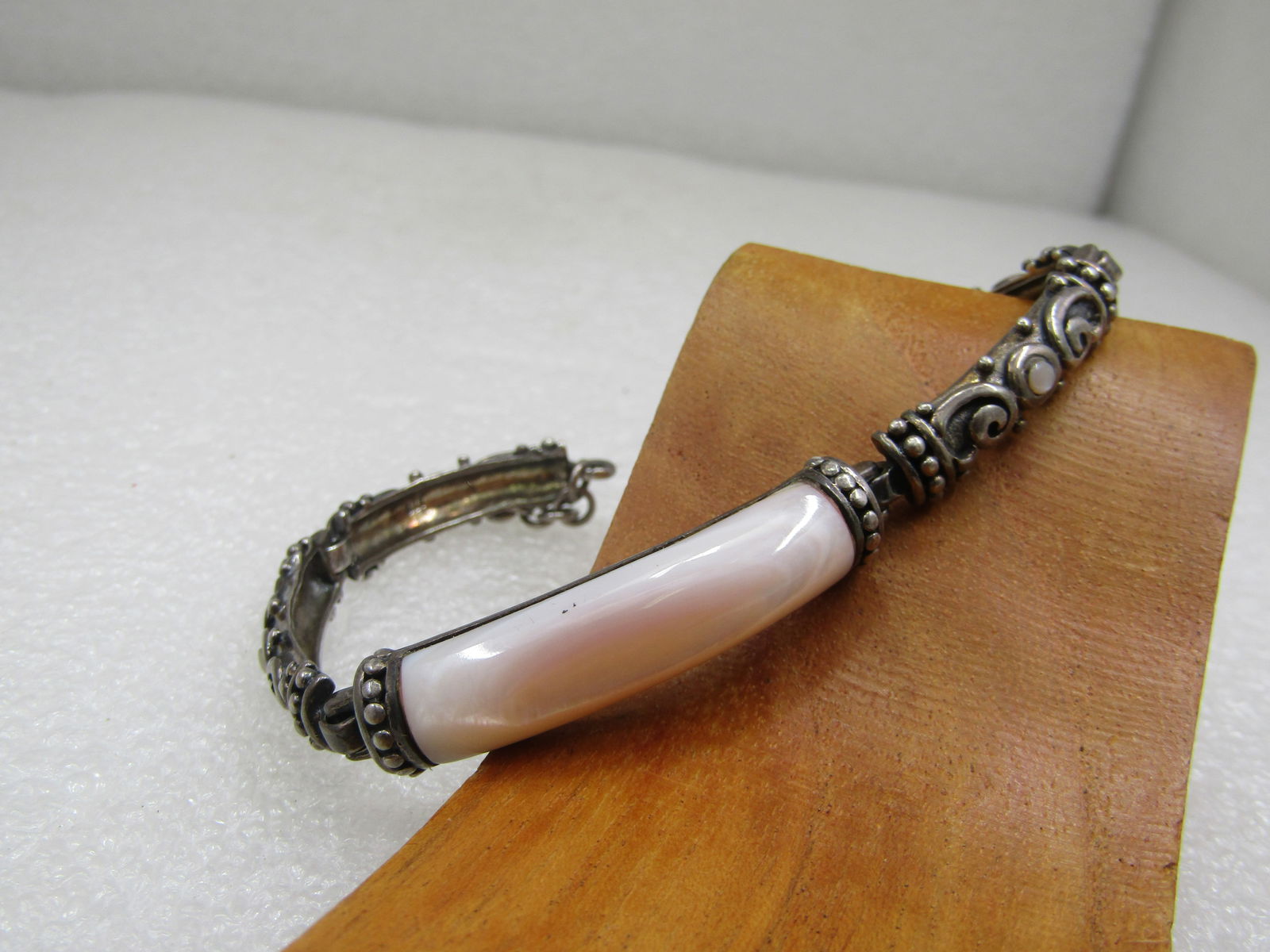 Vintage Sterling Mother-of-Pearl Bali Bracelet, 7.75" Toggle Clasp: Vintage Sterling Mother-of-Pearl Bali Bracelet, 7.75" Toggle Clasp. Curved center pink mother-of-pearl that is appx. 34mm long and 9mm wide set on sterling with end bezels with a beaded design.
