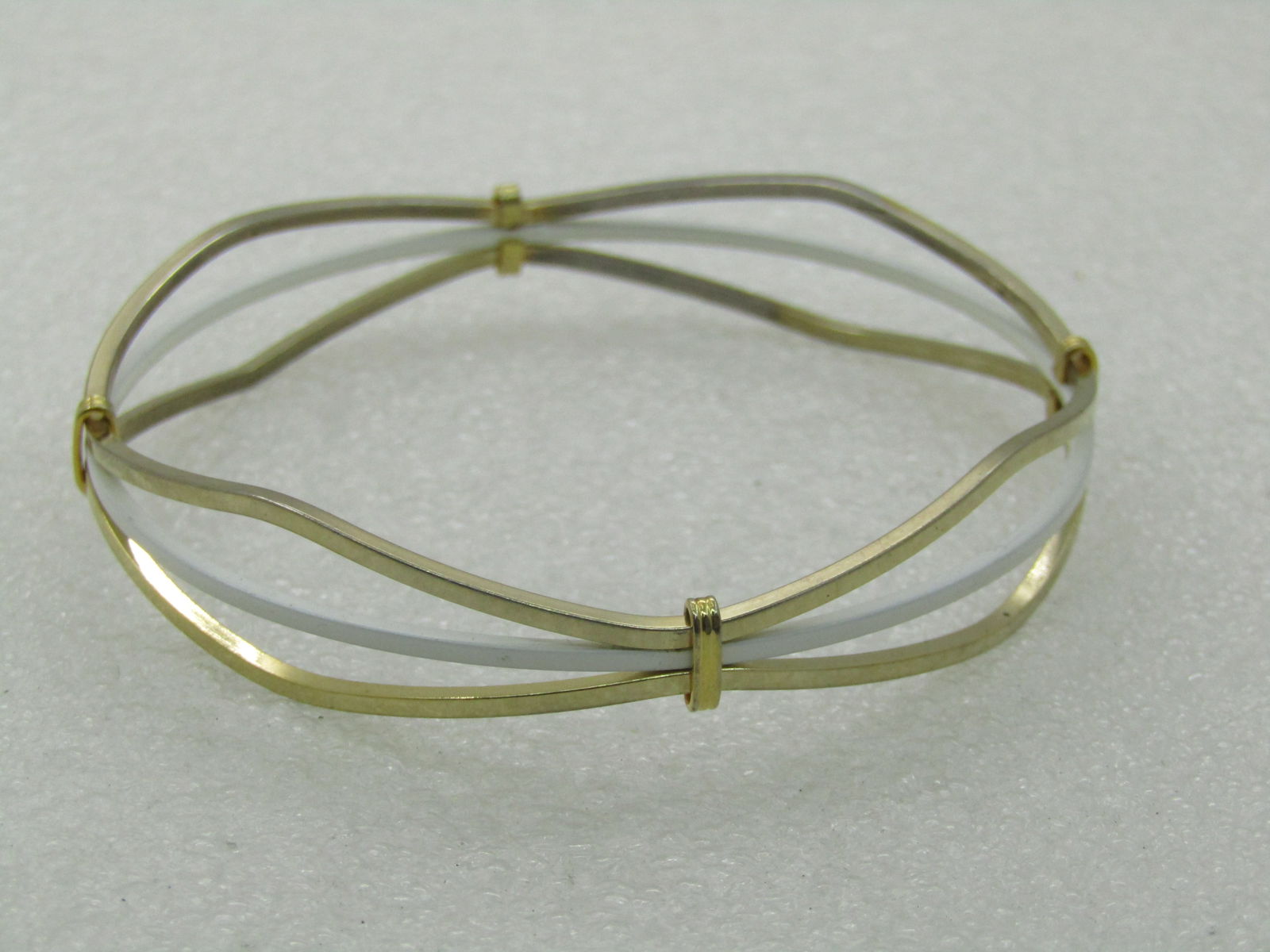 Vintage White Enameled & Gold Tone Bangle Bracelet, 7.5"m 1960's: Vintage White Enameled & Gold Tone Bangle Bracelet, 7.5"m 1960's - angular triple strand bracelet with told tone on the outer edges and white enameled in the center. The gold tone bands are slightly