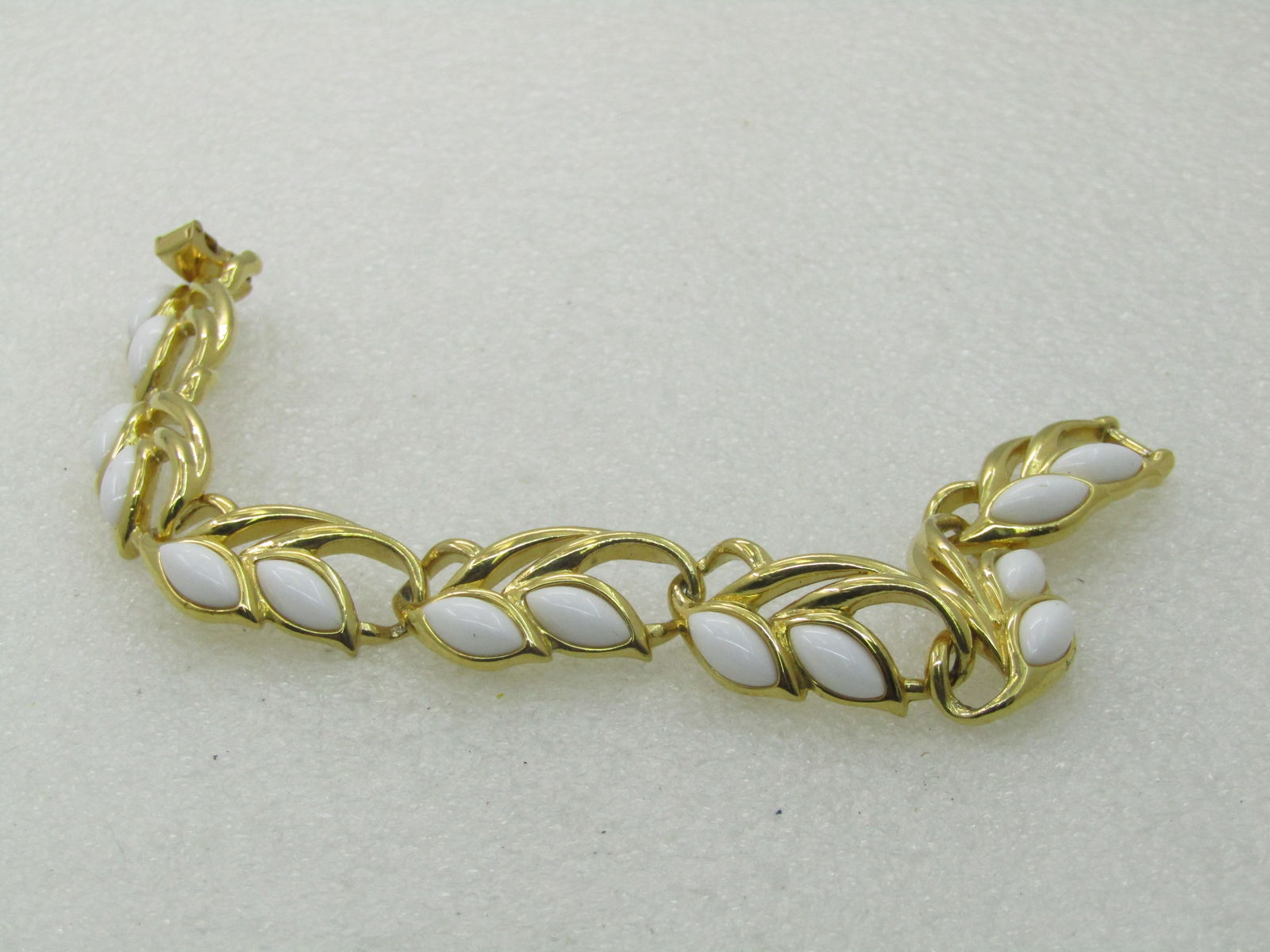 Vintage Trifari White Stoned Bracelet, Art Deco Themed, 7.25" Gold Tone, 1970's-1980's: Vintage Trifari White Stoned Bracelet, Art Deco Themed, 7.25" Gold Tone, 1970's-1980's. It is appx. 5/8" wide , flipover clasp. Very good, like new condition. (INV. W.11.1619.5) Reserve: $30.00 