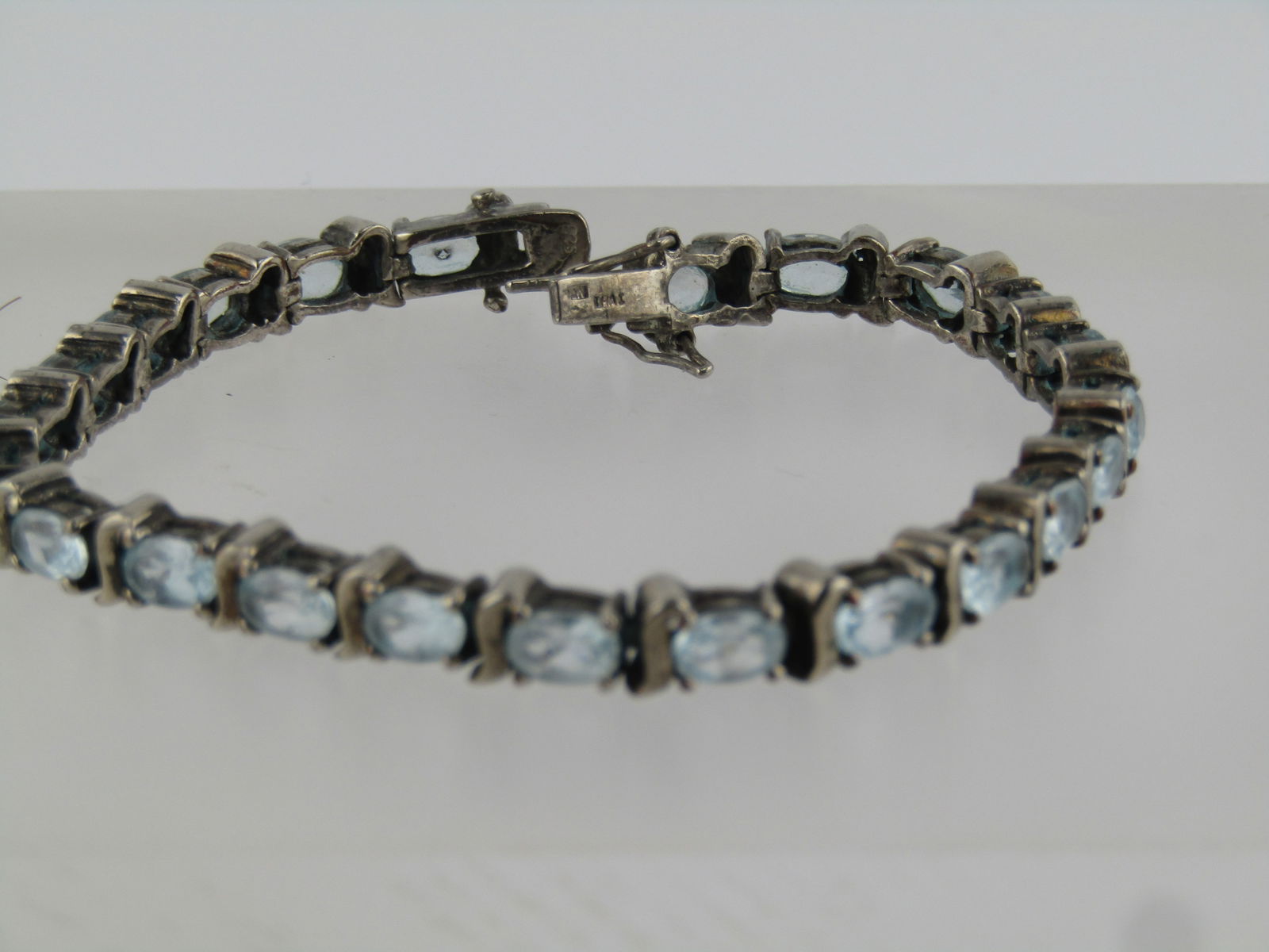 Vintage Sterling Silver Blue Topaz Bracelet, 7.25", Signed, 1980's: Vintage Sterling Silver Blue Topaz Bracelet, 7.25", Signed, 1980's. This has twenty-three oval blue topaz prong-set links. Each topaz is appx. 6mm by 4mm. Between each of the topaz stons is a