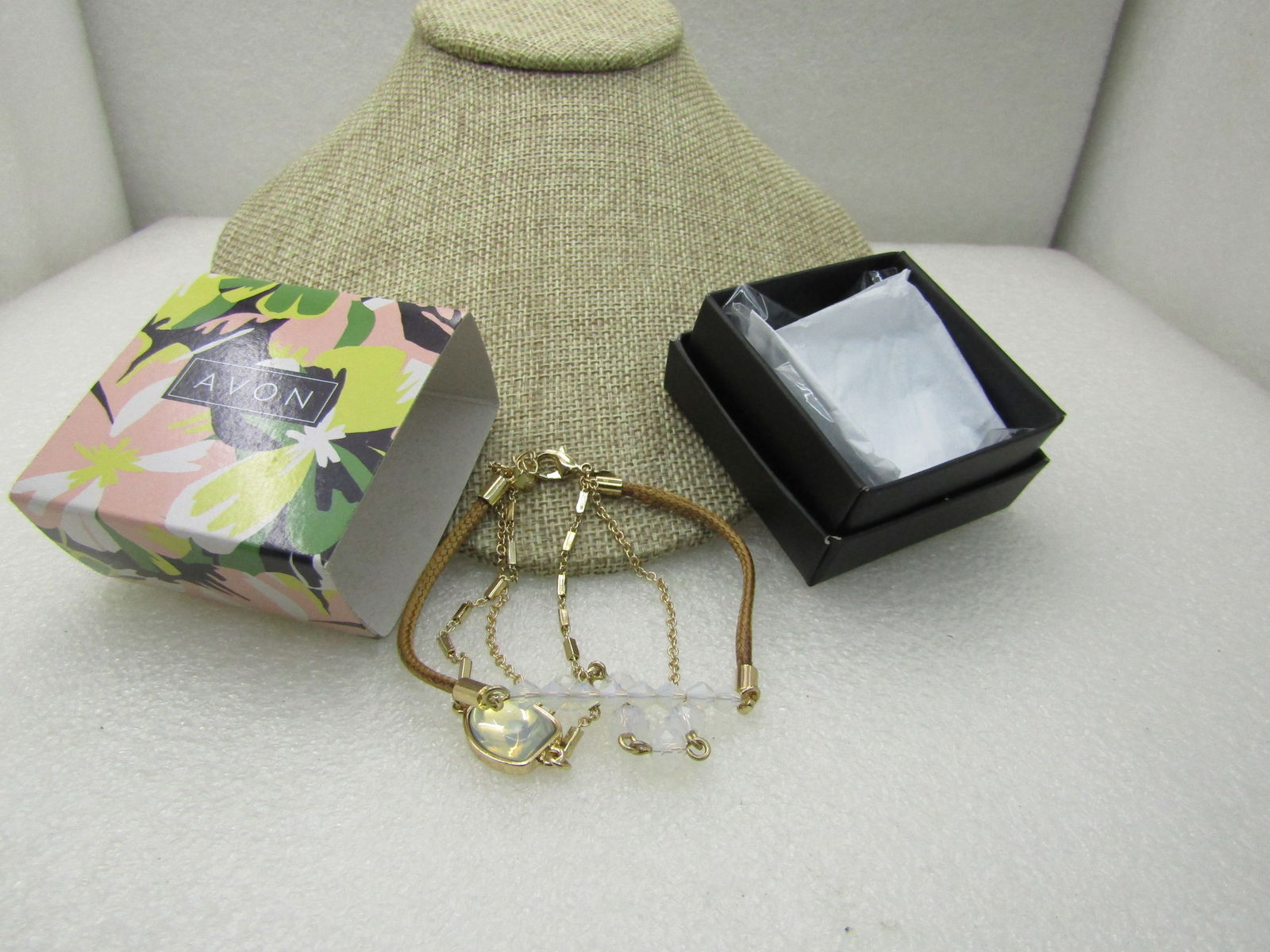 Avon Multi-Strand Opalesque Layered Bracelet. 7-8", In Original Box, Unworn: Avon Multi-Strand Opalesque Layered Bracelet. 7-8", In Original Box, Unworn. 2019 triple strand Opalesque bracelt by Acvon. Gold tone braided corn, bar link and chain lik with center Opally glass