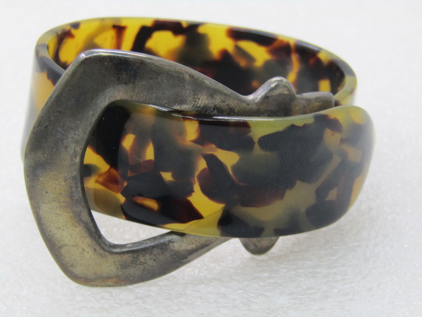 Vintage Faux Tortoiseshell Belt Bracelet, 7": Vintage Faux Tortoiseshell Belt Bracelet, 7" with an opening of 2.5" side-to-side and 2" front-to-back. This will take a slender wrist. You can push the tip of the belt with your thumb to open up the