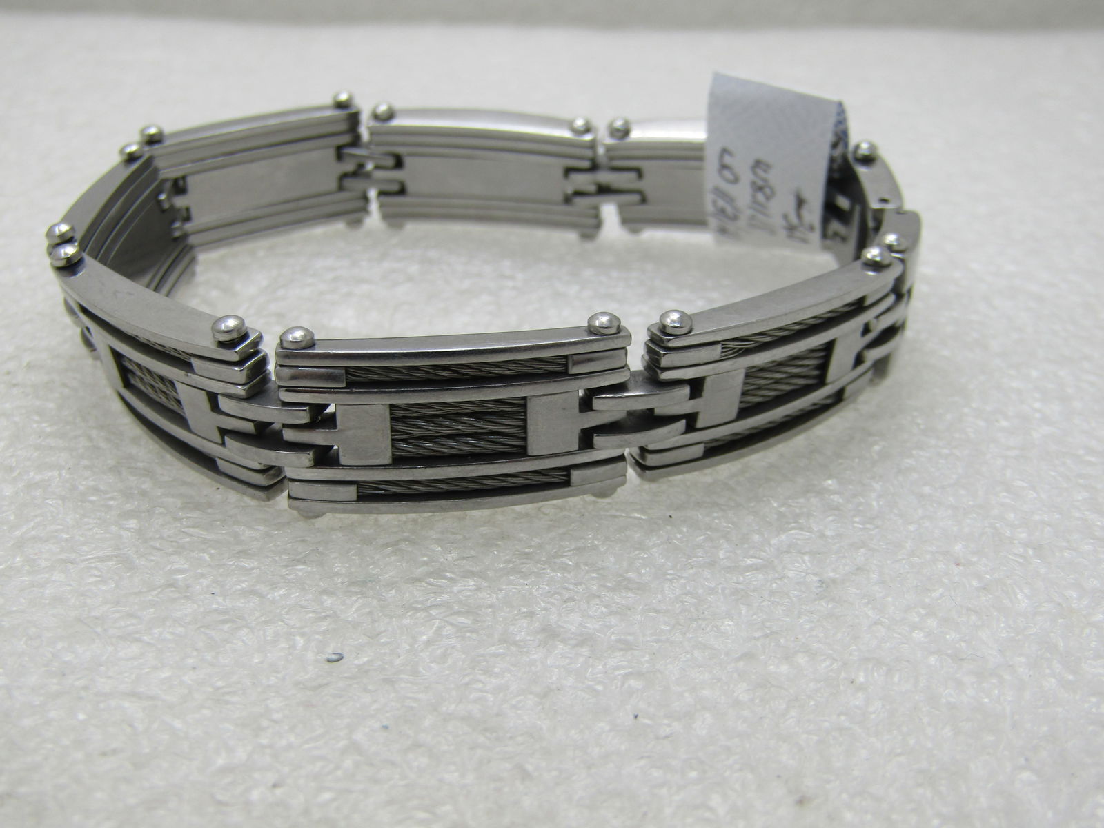 Men's Stainless Steel Cable Linked Bracelet, 8.5": Men's Stainless Steel Cable Linked Bracelet, 8.5" long and slightly 5/8" wide. Stainless Steel signed with each link have five strands of twisted cable channel set in recessed grooves in the link.