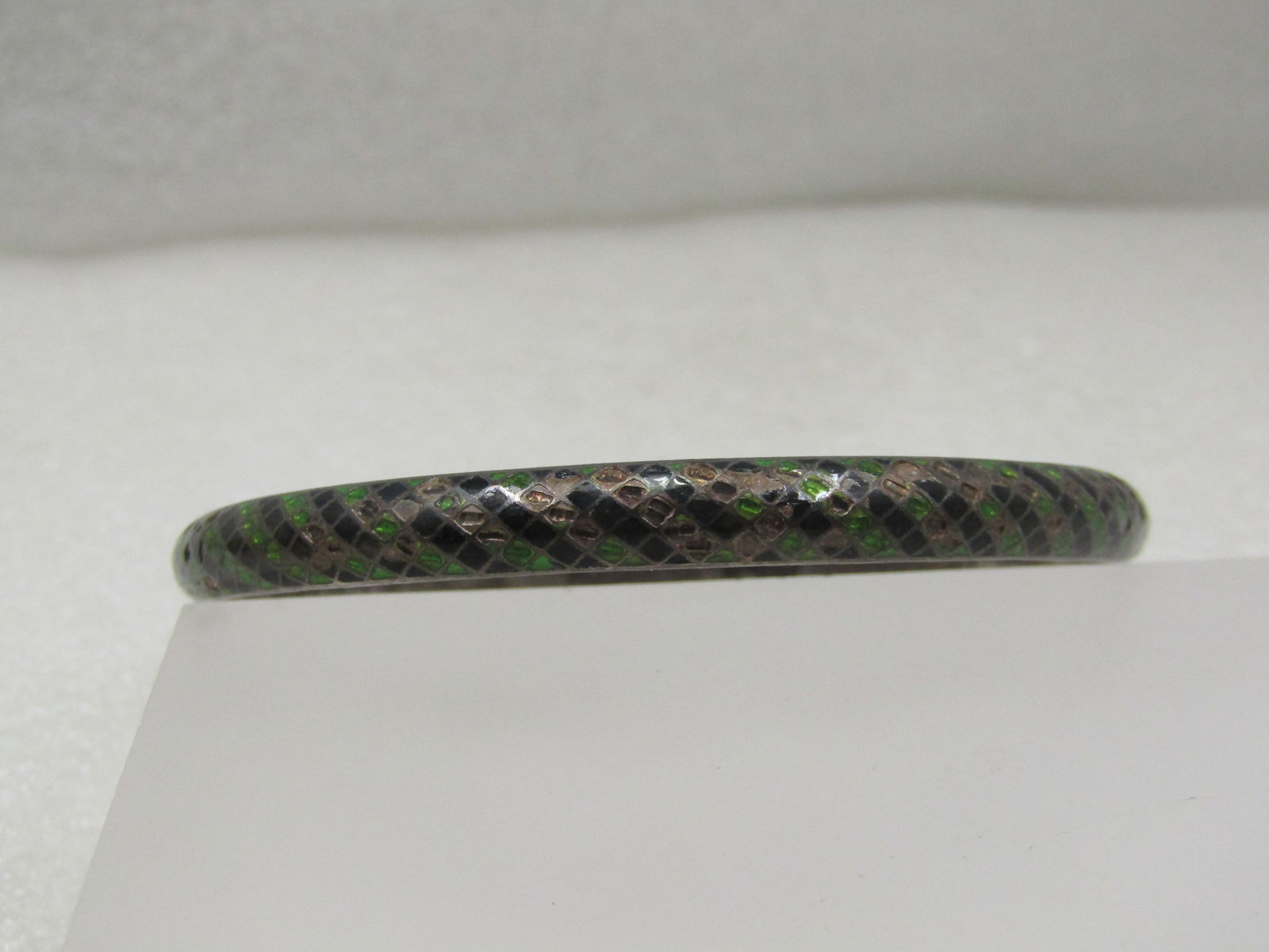 Vintage Sterling Enameled Black & Green Bangle Bracelet, 8.25" India: Vintage Sterling Enameled Black & Green Bangle Bracelet, 8.25" India. The bracelet is domed on the outside with alternating green and black enameling - some of the enameling is worn . It is marked