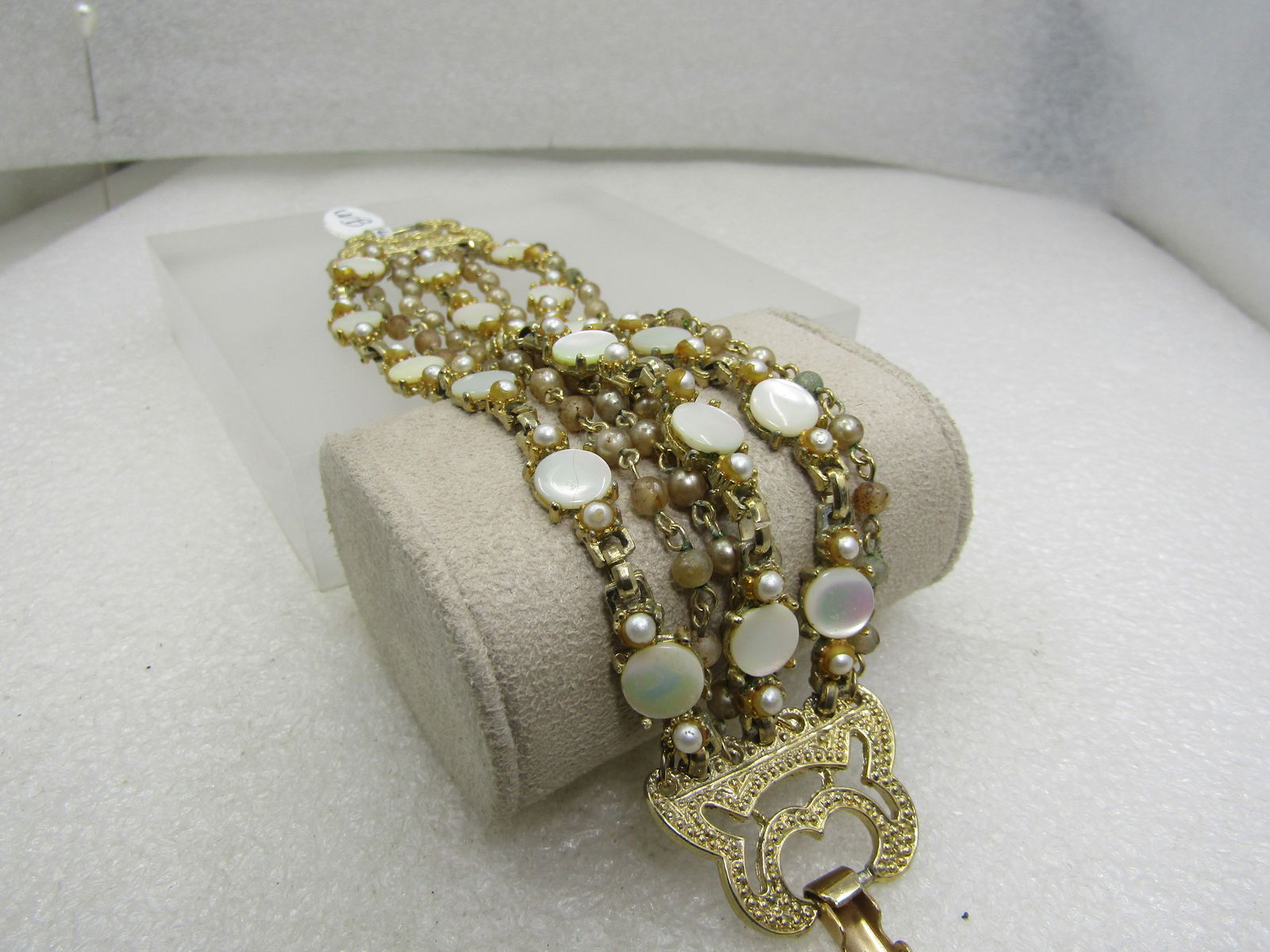 Vintage 7 Strand Mother-of-Pearl Bracelet, Gold Tone, 7": Vintage 7 Strand Mother-of-Pearl Bracelet, Gold Tone, 7" and appx. 1.5" wide. This has three strands of appx 1/3" round mother-of-pearl disks and faux pear beaded strands. Four strands are all faux