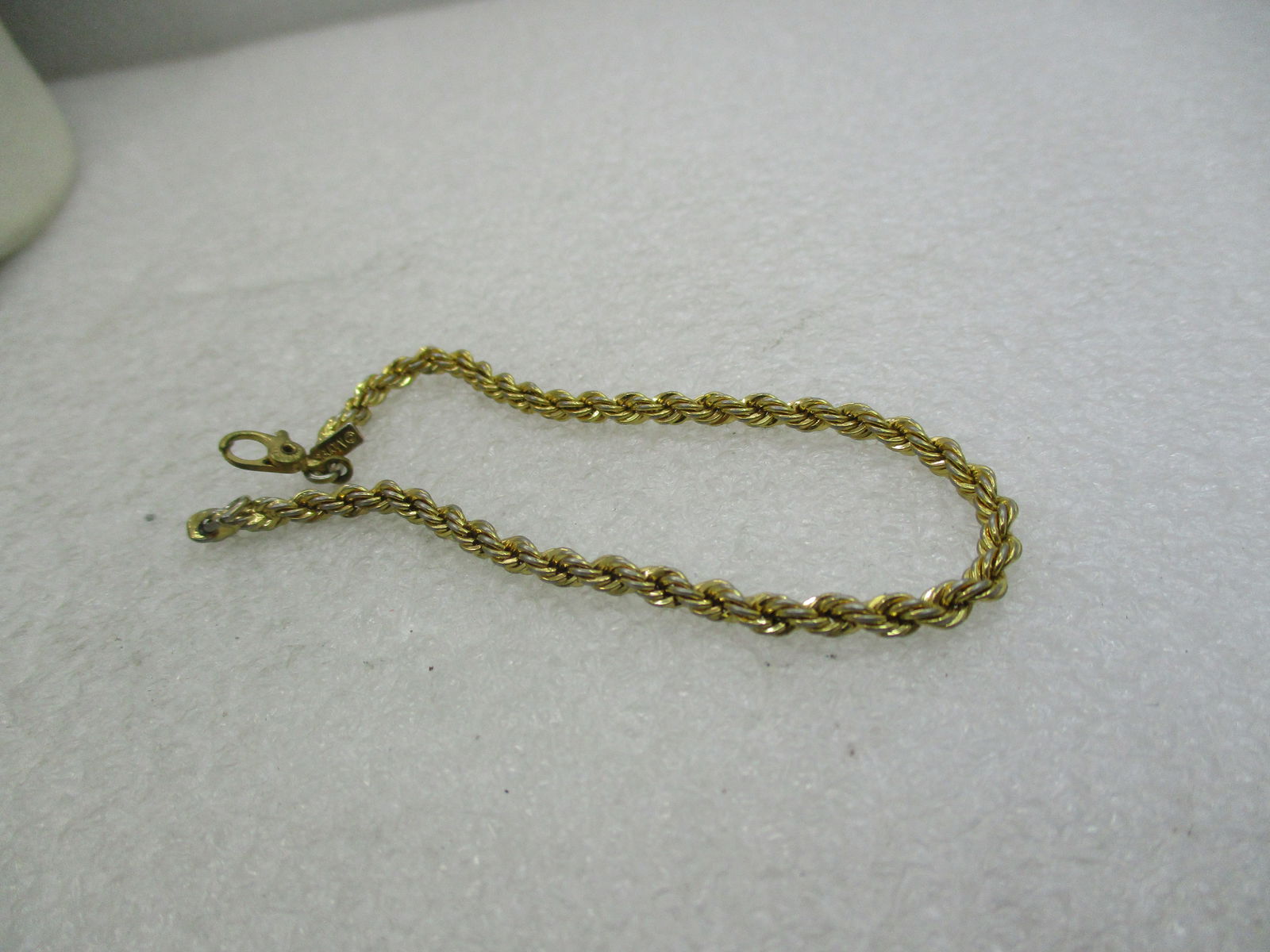 Vintage Monet 3mm Twisted Rope Chain Bracelet, 7.25", 1960's-1970's: Vintage Monet 3mm Twisted Rope Chain Bracelet, 7.25", 1960's-1970's. Gold tone. This has the sliding hand-cuff style clasp. Light wear. Good condition. Signed Monet on the clasp and with the dangling