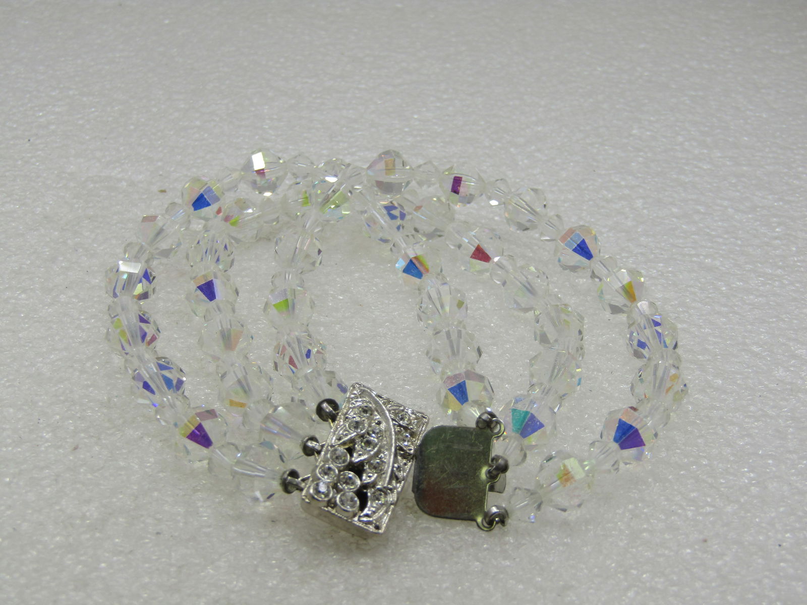 Vintage Triple Strand Aurora Borealis Crystal Rhinestone Bracelet, 7.5": Vintage Triple Strand Aurora Borealis Crystal Rhinestone Bracelet, 7.5" with ornate rhinestone art deco box clasp. 1960's. Not signed by the maker. Very good condition. (INV. W. 21414.1X1 SS5218 J LD