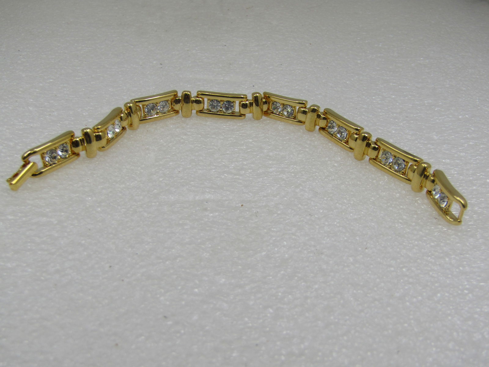 Vintage Joan Rivers Rhinestone Bracelet, 7.75": Vintage Joan Rivers Rhinestone Bracelet, 7.75" and 8.5mm wide. each links has two round rhinestones set with open area to the side of each stone and a vertical bar connector link between each link. Fl