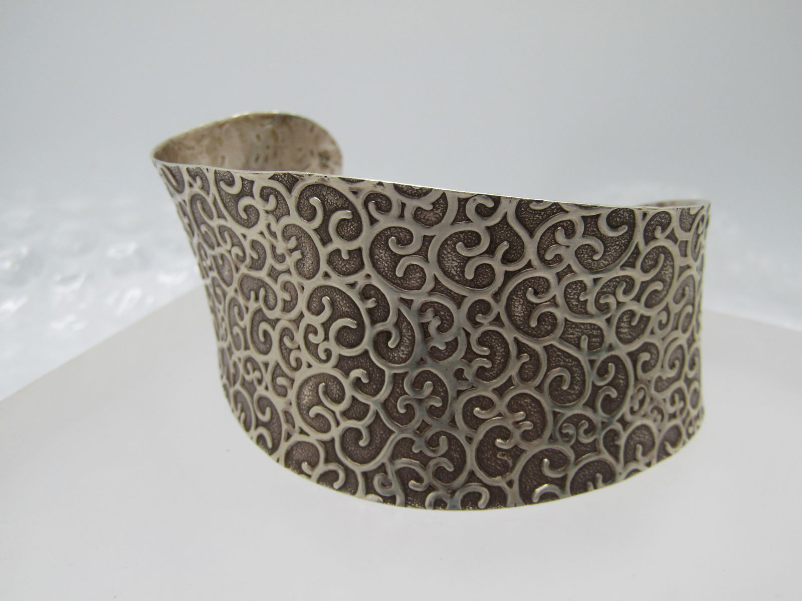 Vintage Sterling Abstracted Scrolled Cuff Bracelet, 7": Vintage Sterling Abstracted Scrolled Cuff Bracelet, 7". This has a textured background with raised scrolls over the entire bracelet . It is apx. 1-3/8" wide at the wides point and lessens to appx.