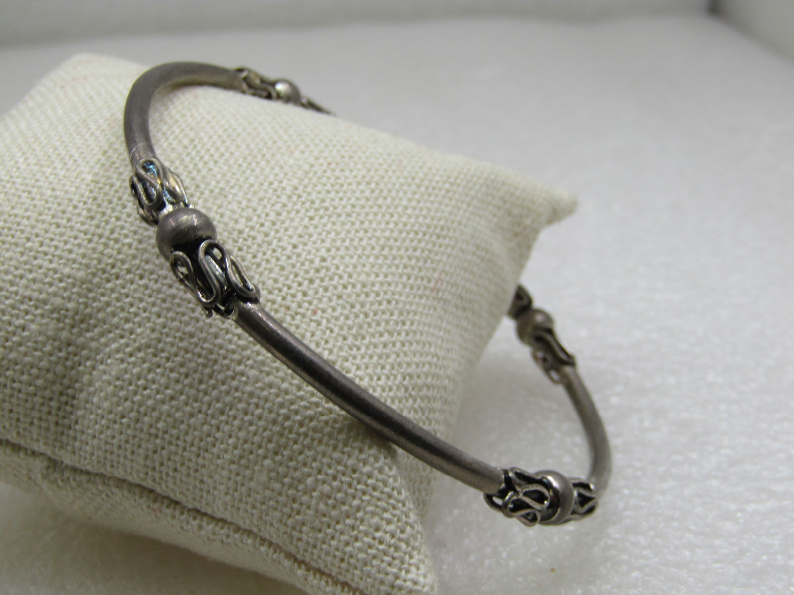 Silver Tone Bali Bangle Bracelet, 8": Silver Tone Bali Bangle Bracelet, 8", great for the larger wrist. 2-7/8" opening. Unisex. Boho appeal too. 3mm round with accents on four areas equally spaced around the bracelet. There is a 6mm bead