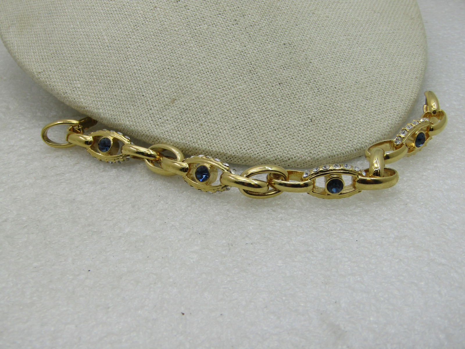 Nolan Miller Faux Sapphire Bracelet, 7" (SS784): plain links at 7.5mm wide with rhinestone edged links at 10mm with a center deep blue sapphire clored rhinestone. Flip Clasp. (INV. AX3320.1X1, SS784, DA44, LD 3/15/20) Reserve: $30.00 Shipping: Domes