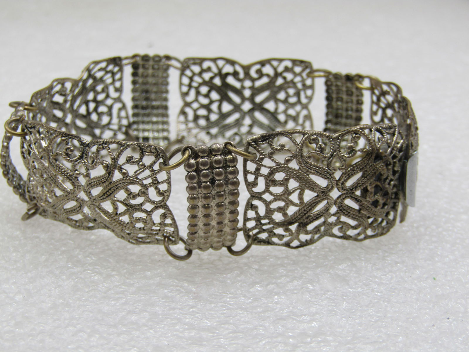 Vintage Silver Tone Filigree Wide Bracelet, 8", 1930's: Vintage Silver Tone Filigree Wide Bracelet, 8", 1930's. 7/8" wide with a light-weight filigree design in fived domed links with a dotted grid connector certical link between each filigree link. Box cl