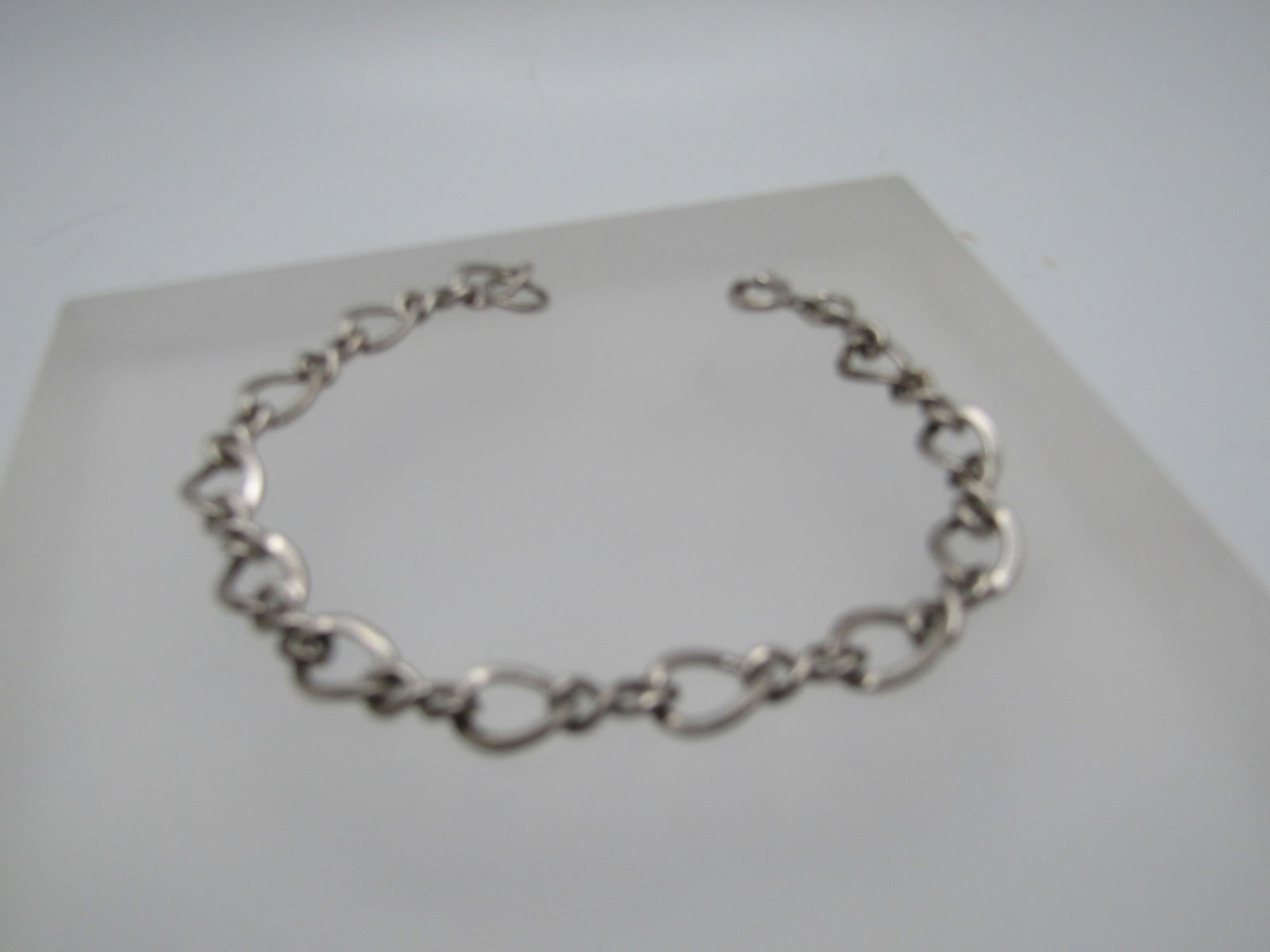 Vintage Sterling 7mm Chain Link Bracelet, 7.5": Vintage Sterling 7mm Chain Link Bracelet, 7.5" signed Automade Sterling. It has a curved wider link that is appx. 7mm wide with a twisted eight connector link that is appx. 4 mm wide. Spring clasp. Ag