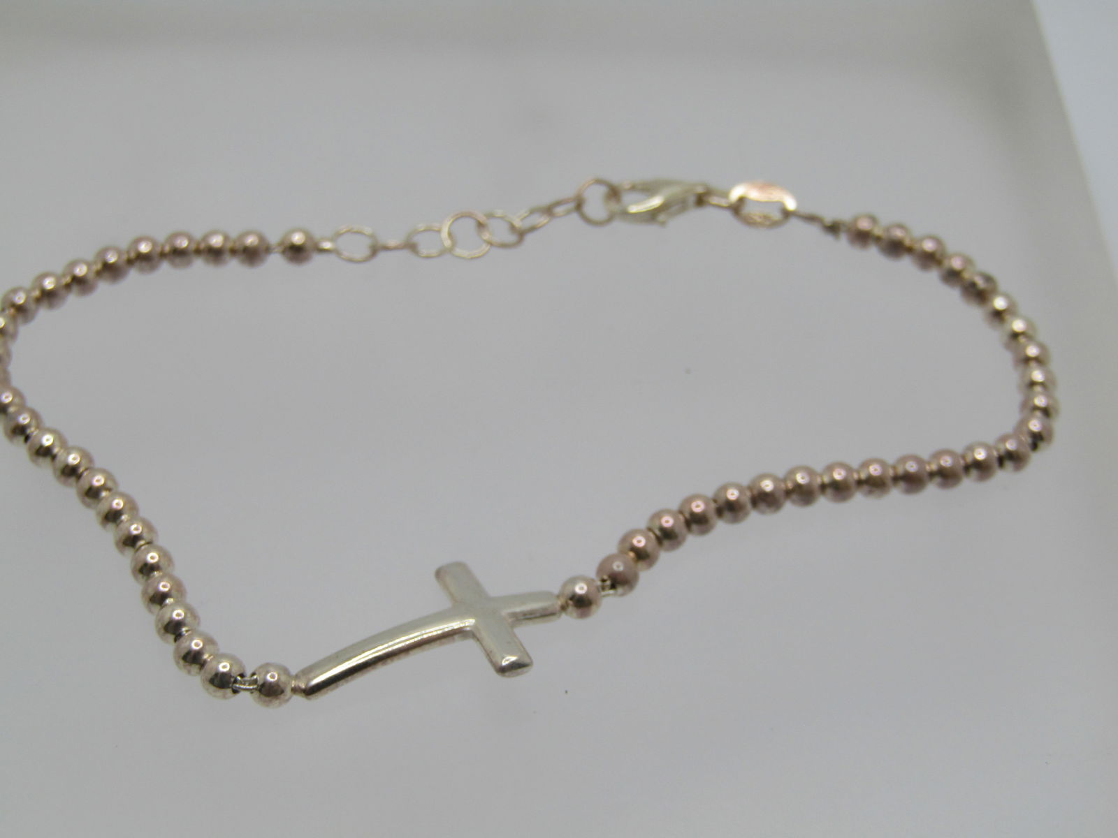 Sterling Silver Cross Beaded Bracelet, 7.25" to 8.25", Signed: Sterling Silver Cross Beaded Bracelet, 7.25" to 8.25", Signed SXI, marked .925 and tested with a weight of appx. 5.67gr. Italy. The cross is set in the center of the 3mm beaded bracelet and is
