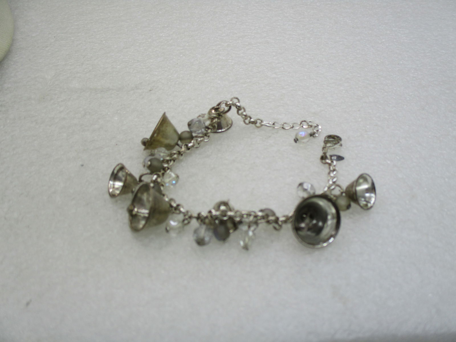 Vintage Avon Bell & Crystal Bracelet, Silver Plated, 7" Plus: Vintage Avon Bell & Crystal Bracelet, Silver Plated, 7" with 1.25" extender chain. Graduated Silver plated bells on a silver plate rolo chain bracelet with dangling crystal beads and round frosted bea