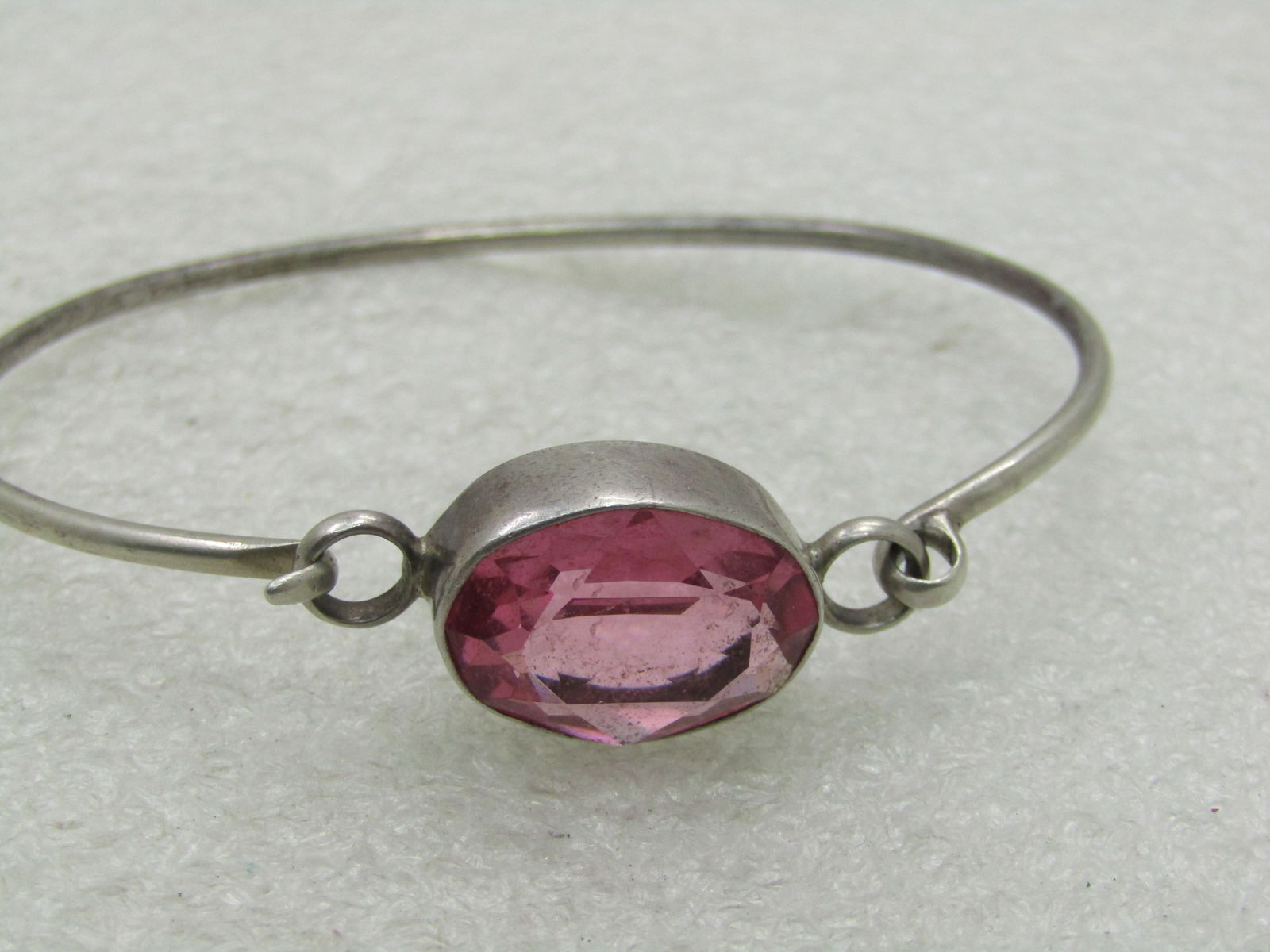Vintage Sterling Silver Pink CZ Bangle Bracelet, Top Hook, 7", 10.25 grams, 1960's: Vintage Sterling Silver Pink CZ Bangle Bracelet, Top Hook, 7", 10.25 grams. 1960's. The stone is appx. 18.5mm by 15.5mm, bezel-set. Top hook. The band is appx. 2mm thick. Good condition with some ligh