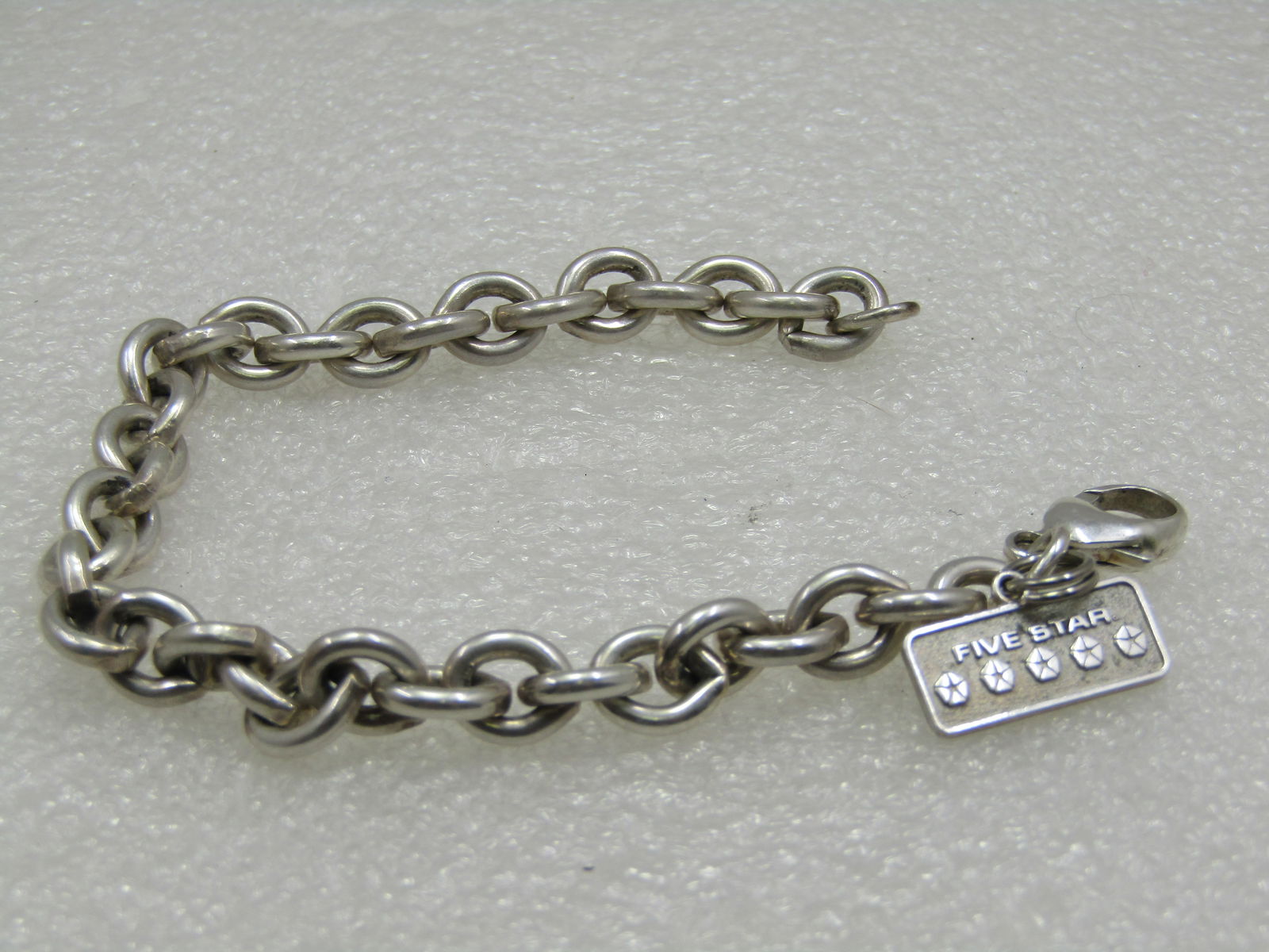 Vintage Sterling Silver Chunky Bracelet with Five Star Charm, 7.5": Vintage Sterling Silver Chunky Bracelet with Five Star Charm, 7.5"With heavy links and is appx. 7.5mm wide. Marked .925 on the lobster clasp. Tested. Weight is appx. 27.76 grams. The five star charm i