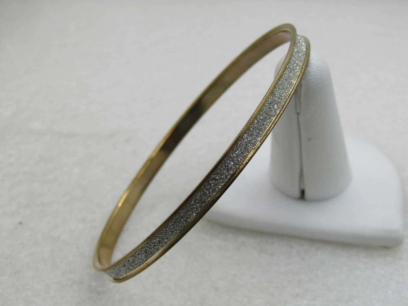 Vintage Two-Tone Bangle Bracelet, 5mm, Glitter Center, 8": Vintage Two-Tone Bangle Bracelet, 5mm, Glitter Center, 8" - gold tone frame with a center of silver glitter. Fits an 8" wrist and under. Grooved center. The glitter is micro-glitter with a very nice s