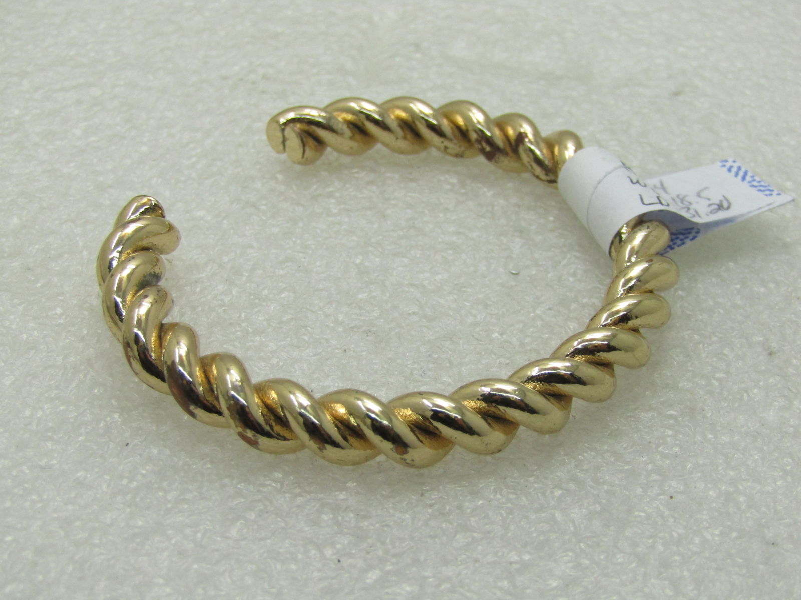 Vintage Gold Tone Twisted Cuff Bracelet, 6", 1960's-1980's: Vintage Gold Tone Twisted Cuff Bracelet, 6", 1960's-1980's. Shiny gold tone in a 1/3" thick twisted cable design with a 1" opening in the back. This bracelet has some movement but I would not force it