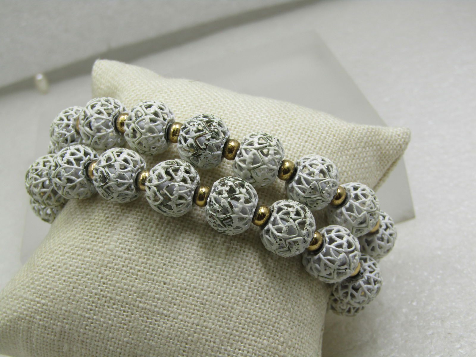 Vintage Monet White Filigree Bracelet, Beaded, Double Strand , 7.5", 1960's-1970's: Vintage Monet White Filigree Bracelet, Beaded, Double Strand , 7.5", 1960's-1970's. Filigree beads that are appx. 11mm round with white enameling and a gold tone 3.5mm spacer bead between each filigre