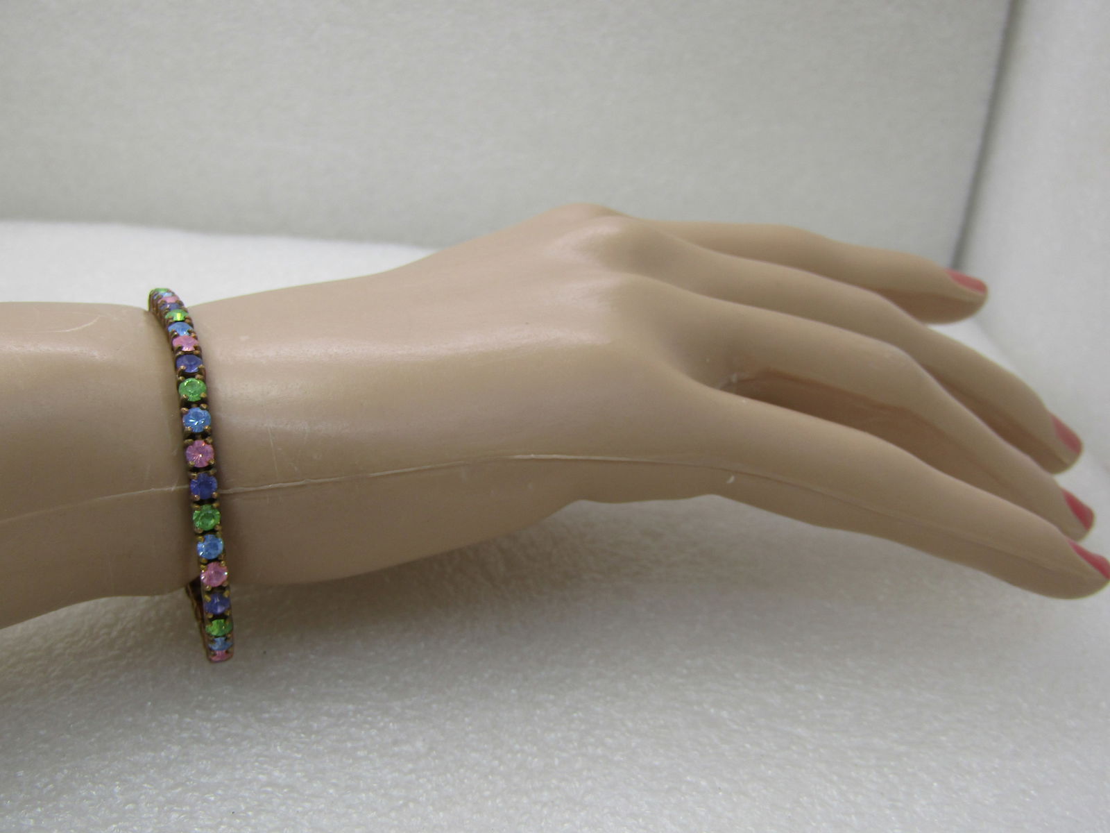 Vintage Joan Rivers Pastel Crystal Tennis Bracelet, 7.75", 3.5mm: Vintage Joan Rivers Pastel Crystal Tennis Bracelet, 3.75", 3.5mmm Yellow/Rose gold tone with box clasp and slide locks. Pink, lavender, blue, green crystals. Good condition, light wear on finish, can