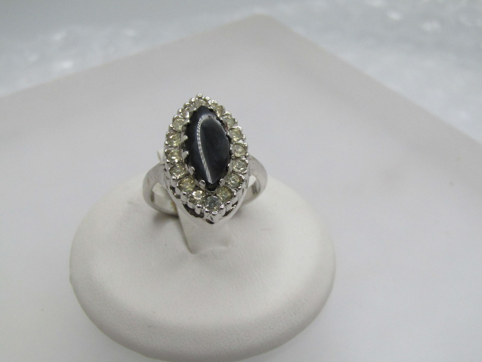 Vintage Black & Clear Rhinestone Ring, Marked Sterling, Sz. 4.5: Vintage Black & Clear Rhinestone Ring, Marked Sterling, Sz. 4.5. This has an 11mm by 5mm marquise black stone that is believed to be glass with a halo of clear rhinestones. The ring is also