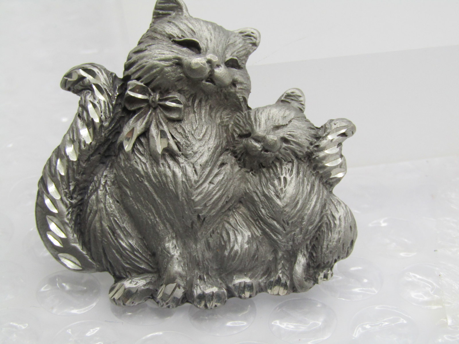Vintage Mom & Kitten Pewter Brooch, Signed SP Antiques: Vintage Mom & Kitten Pewter Brooch, Signed SP Antiques. The mom cat has a bow and there are diamond cut acents throughout the brooch on the tails, bow and paws. Textured finish to look like fur. 