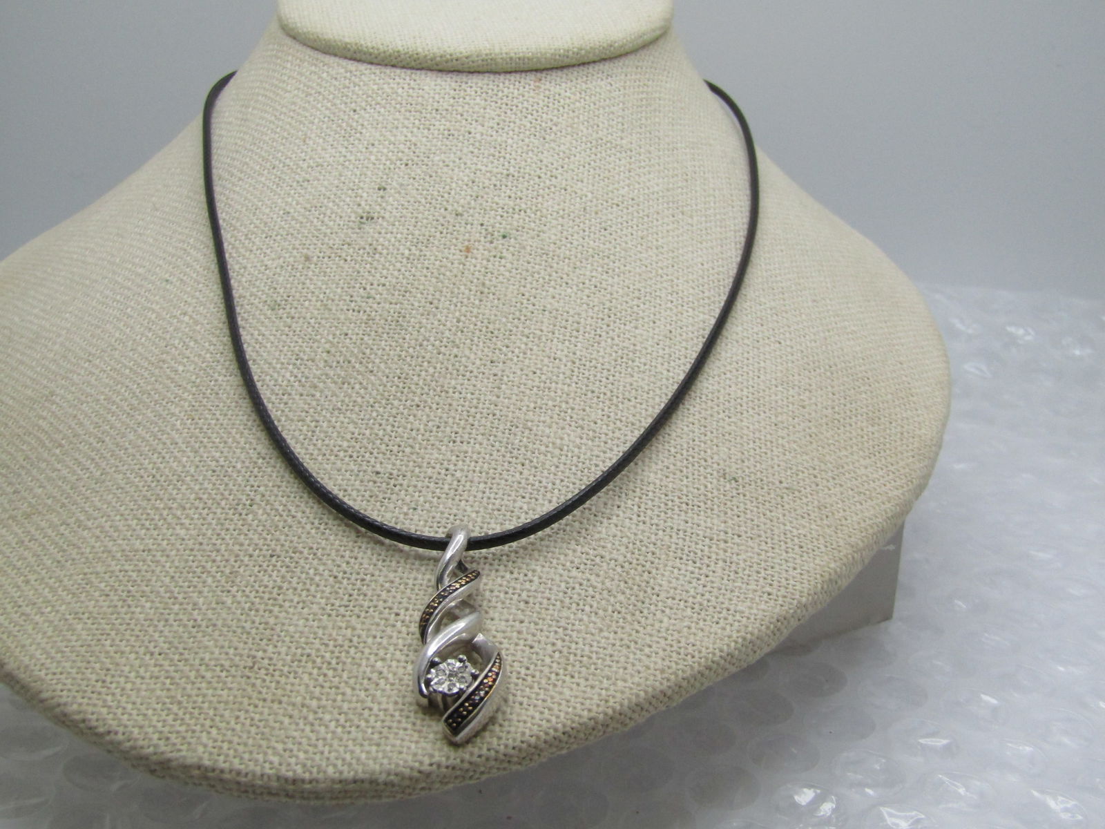 Vintage Sterling & Diamond Twisted Necklace, 20" Signed: Vintage Sterling & Diamond Twisted Necklace, 20" Signed with a $. Marked sterling nd tested with the pendant having a weight of appx. 2.90 gr. The pendant is a smooth twisted and illusion twisted ribb