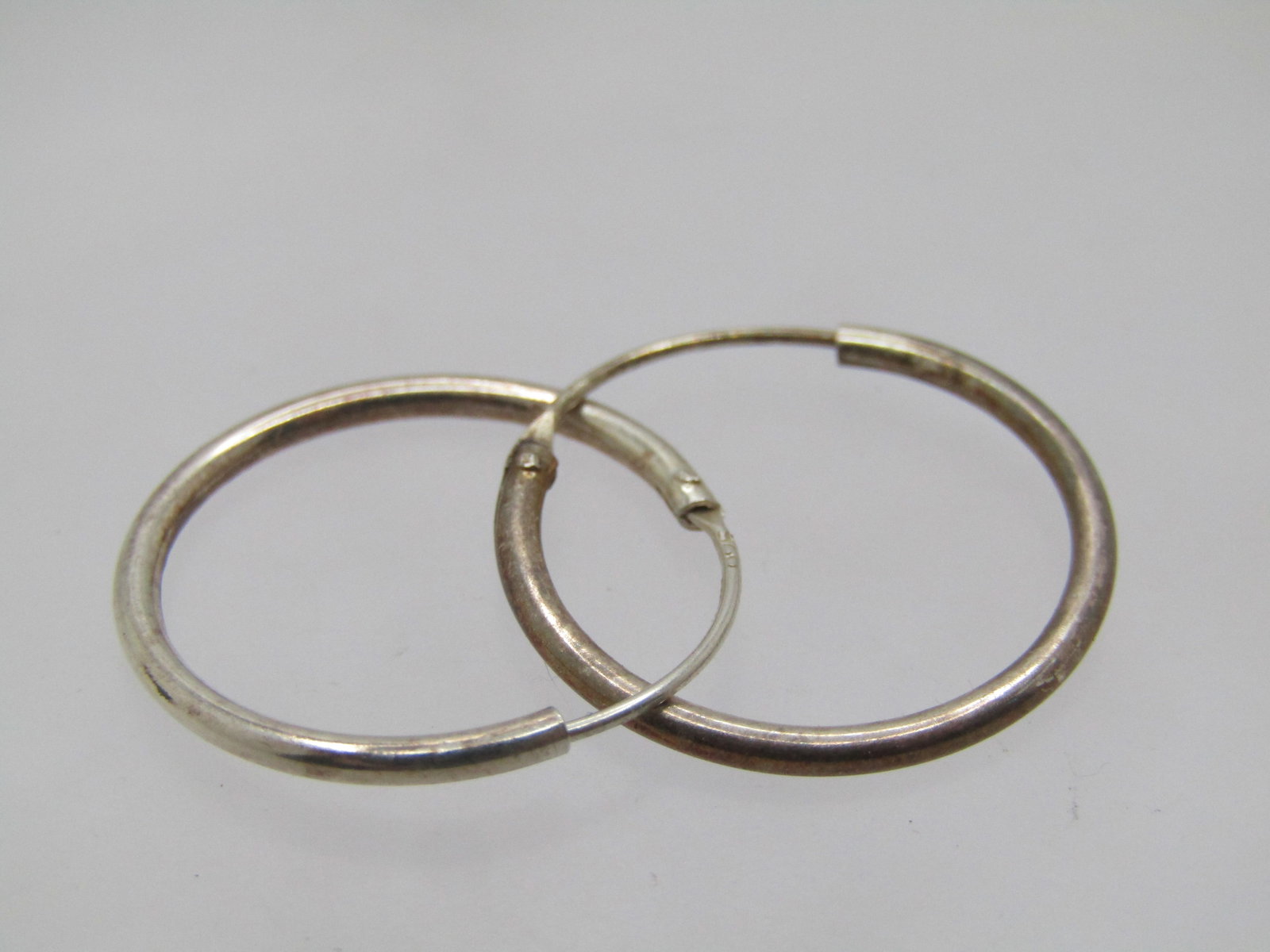Vintage .900 Silver Hoop Earrings, Pierced, 7/8", 1970's-1980's.: Vintage .900 Silver Hoop Earrings, Pierced, 7/8", 1970's-1980's.. They are round tubular in design and appx. 1.4mm thick. The post is rounded and slides into the fram of the tube. They are marked