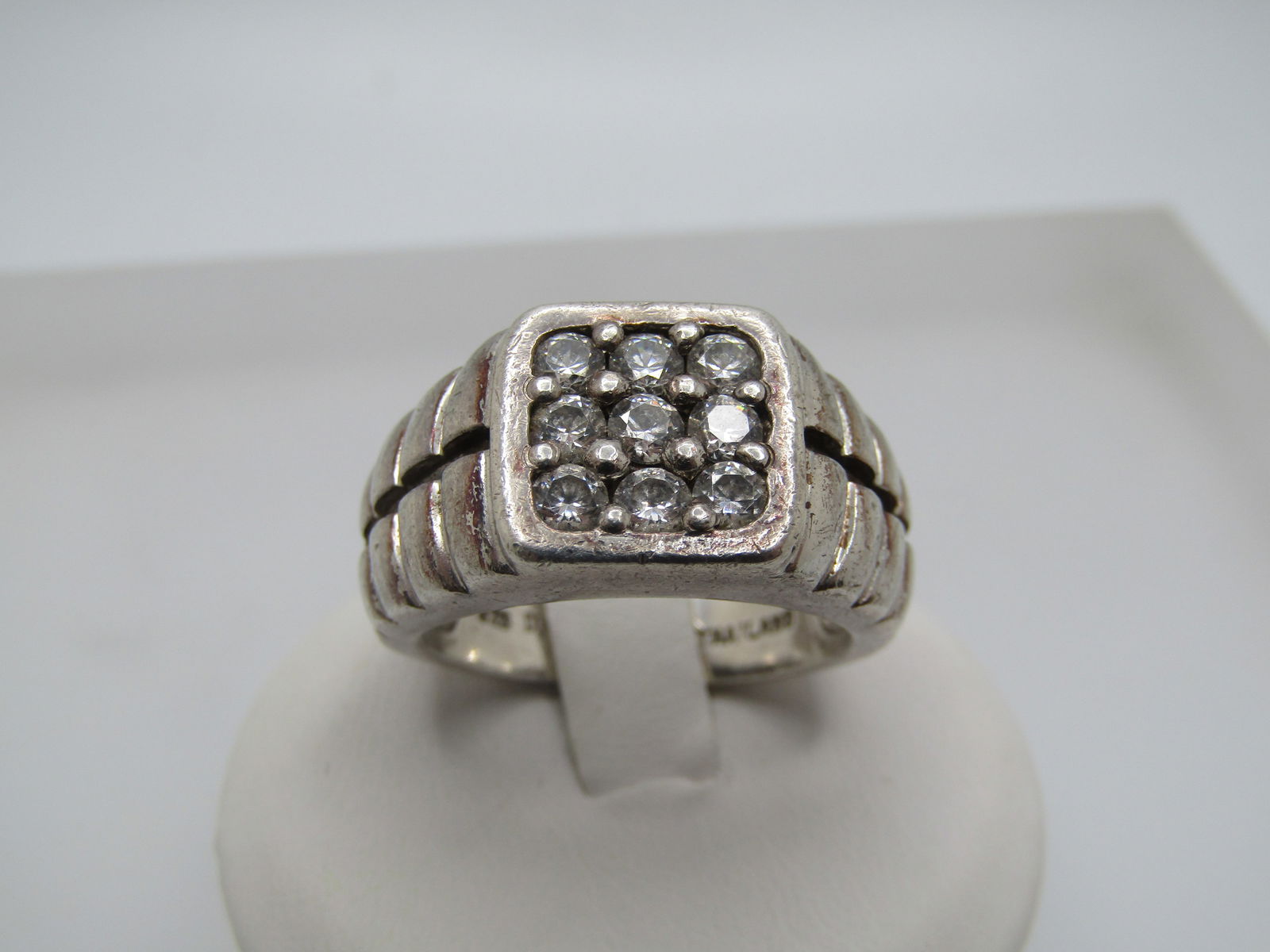 Sterling Silver CZ Men's Ring, Sz. 8, Flat-Top, Diamonique: Sterling Silver CZ Men's Ring, Sz. 8, Flat-Top, Diamonique signed with the DQCZ mark and .925 and tested (weightis appx. 9.75 gr.) Marked Thailand. This has nine round CZs set on the top that are