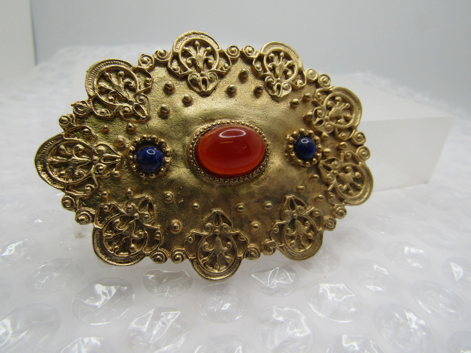 Vintage Amber & Blue Stone Brooch, Victorian Themed, 1980's-1990's: Vintage Amber & Blue Stone Brooch, Victorian Themed, 1980's-1990's. This is appx. 2.75" wide and 2" tall. It has a center amber colored oval cabochon that is glass and appx. 14mm by 10mm with dark
