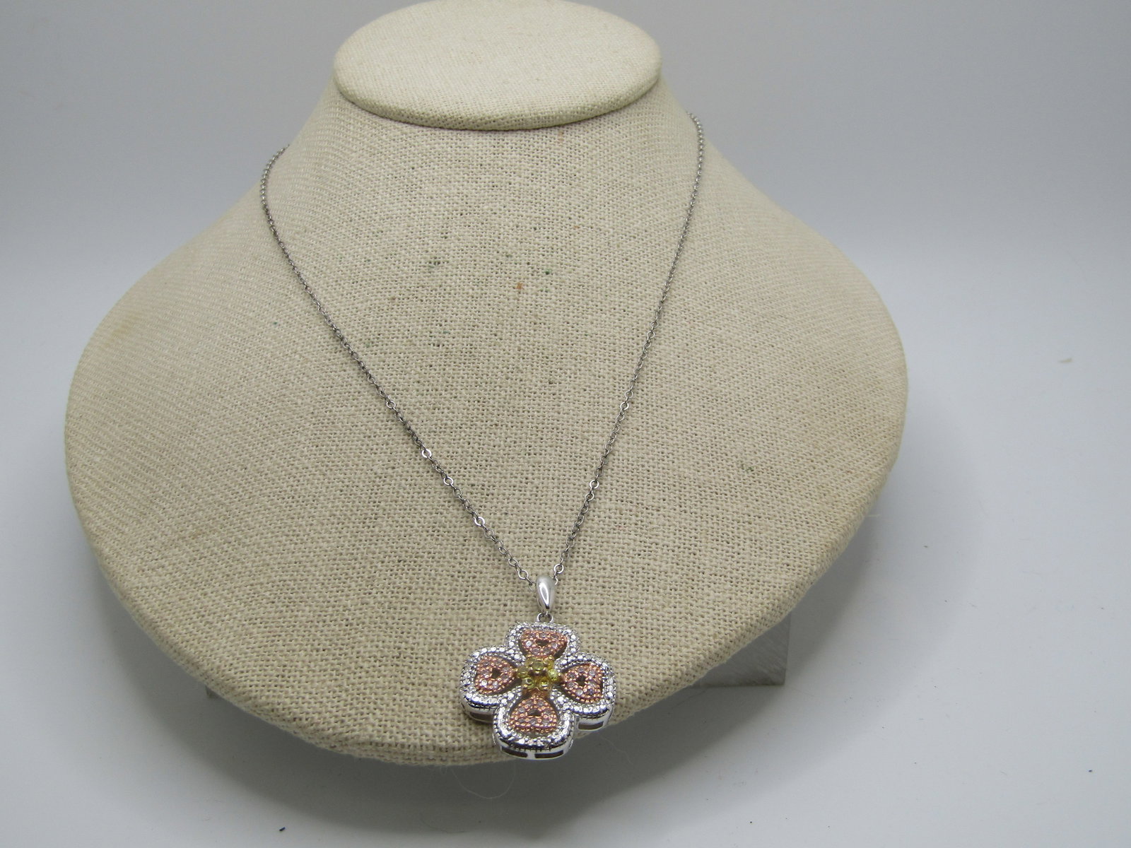 Sterling Sterling CZ Necklace, 18", Heart Blossom Design, Two-Tone: Sterling Sterling CZ Necklace, 18", Heart Blossom Design, Two-Tone. The pendant is appx. 1.25" tall with the bail and 1" wide. It has a silver petal design with a rose gold heart like insert that