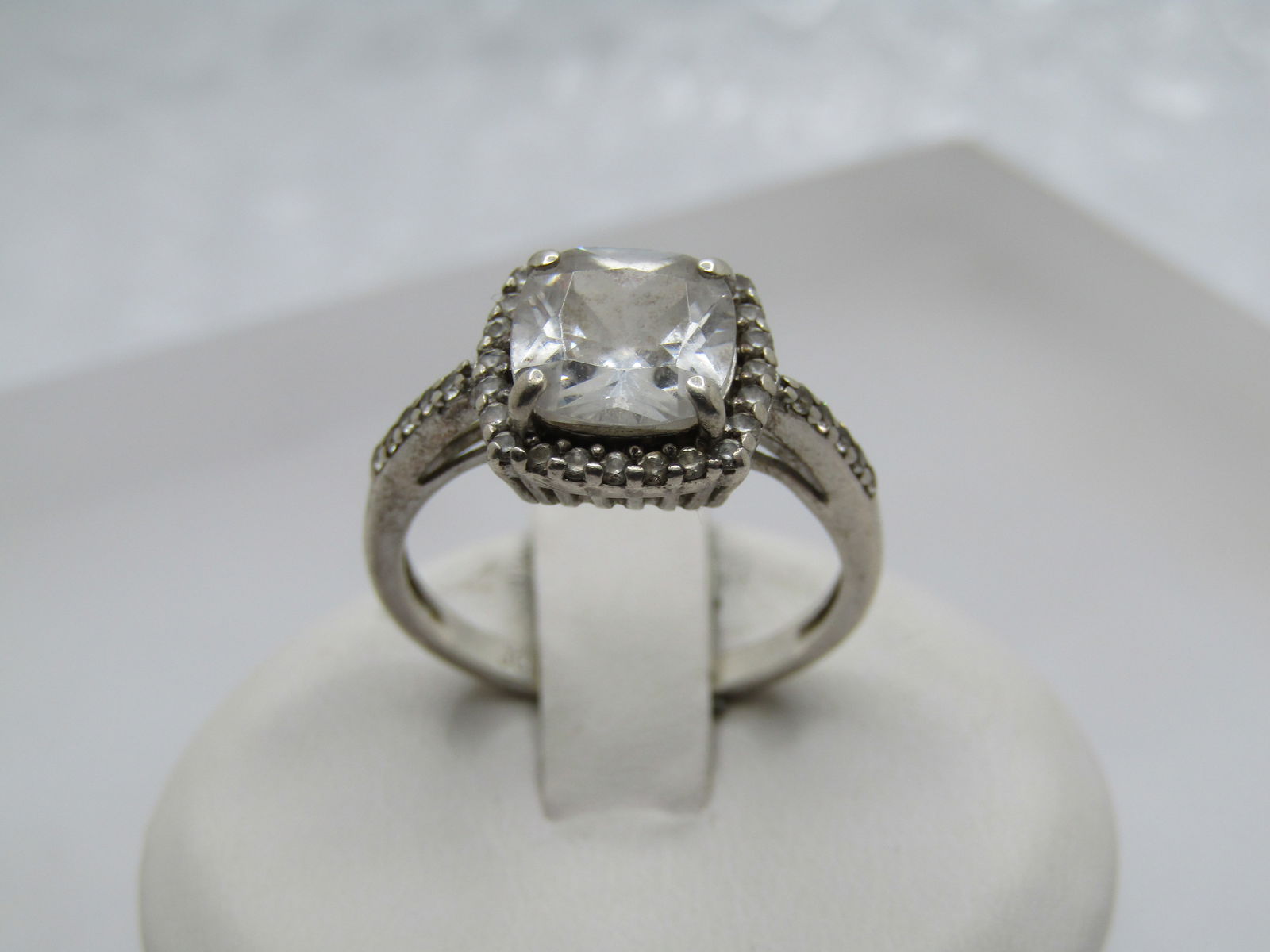 Vintage Sterling CZ Halo Engagement ring, Sz. 7, Appx. 1.5 CTW, Signed: Vintage Sterling CZ Halo Engagement ring, Sz. 7, Appx. 1.5 CTW, Signed JCM (Jacmel) and marked sterling and tested with a weight of appx. 2.97 fr. The stone is a cushion cut square that is appx. 7.5mm