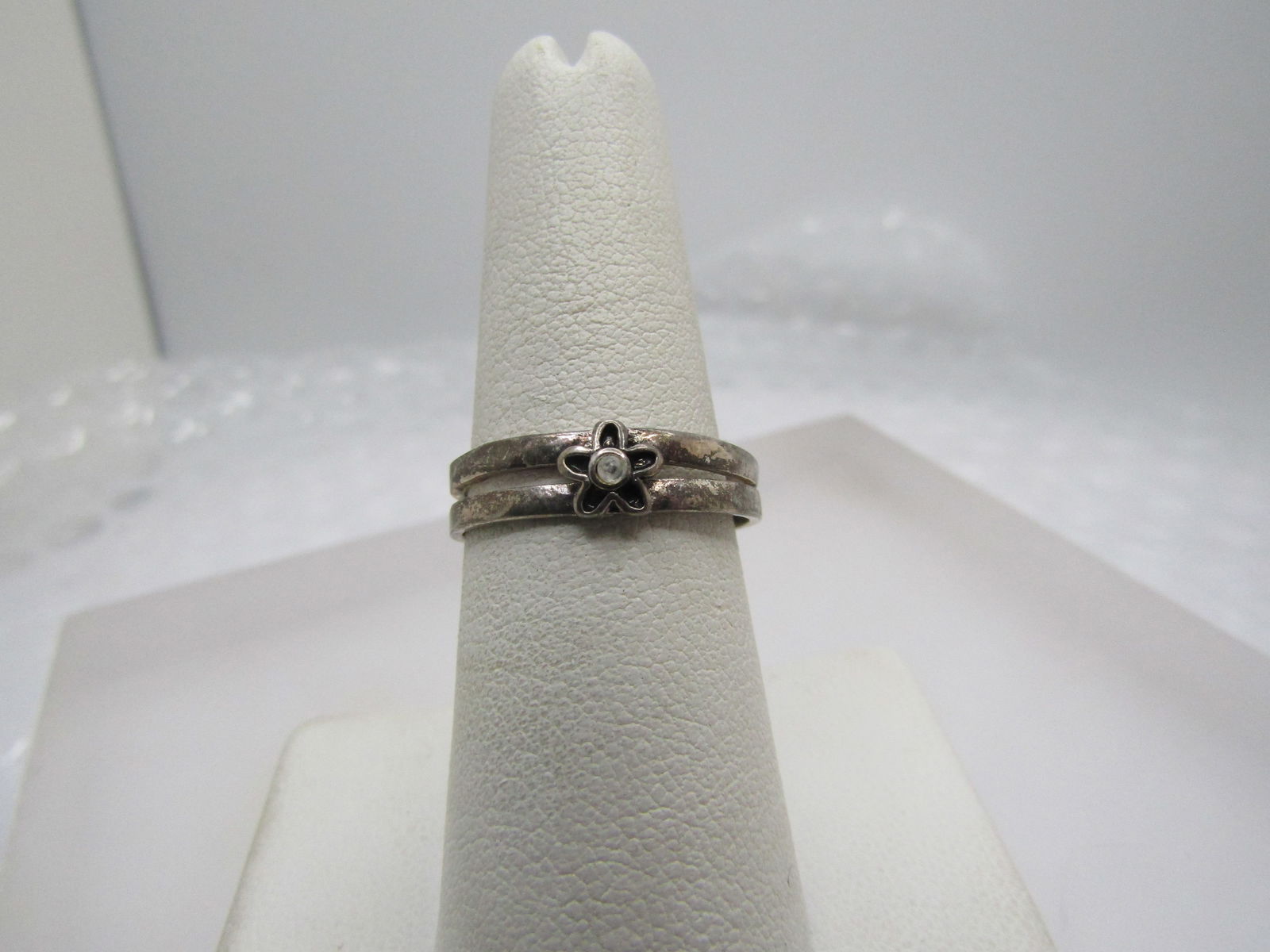 Vintage Floral Toe Ring, With Rhinestone, Adjustable, 1970's-1990's: Vintage Floral Toe Ring, With Rhinestone, Adjustable, 1970's-1990's. This has a blossom on the center with a clear stone. It has a double band with open space between the two bands. The ring is appx.