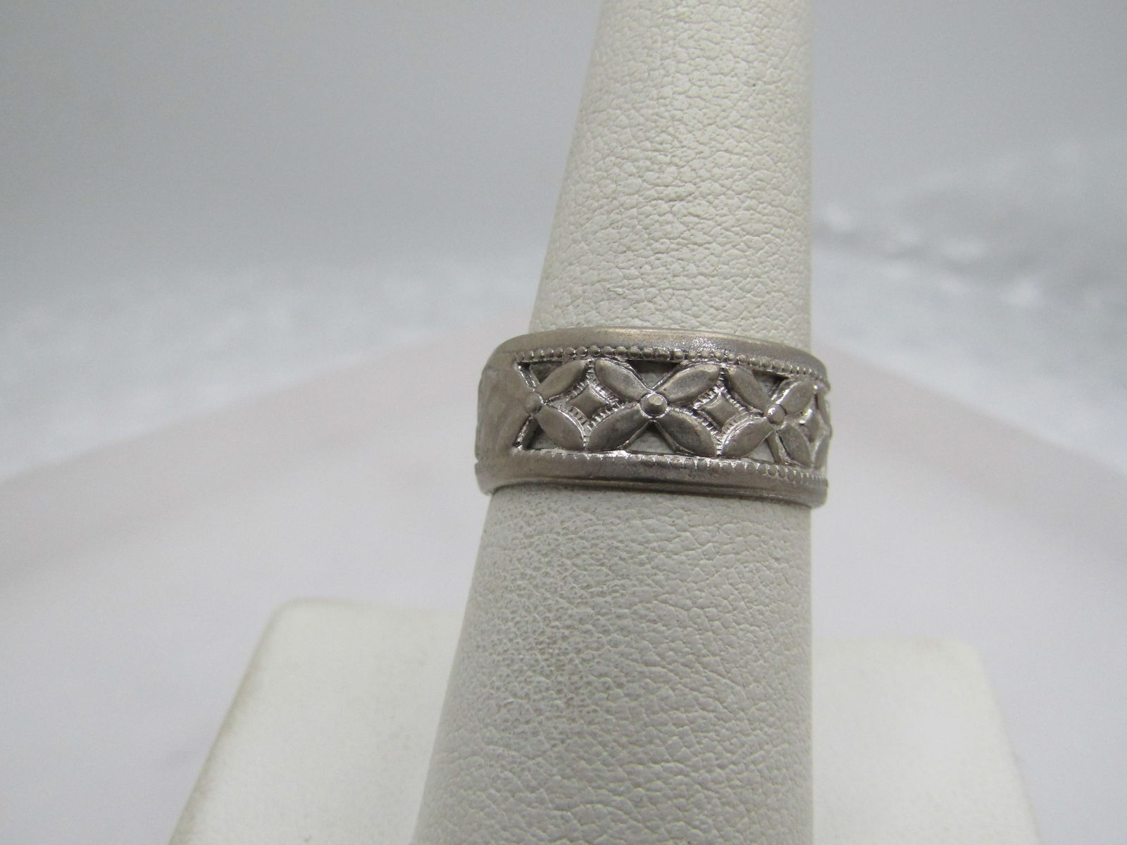 Vintage Sterling Floral Band Ring, Sz. 7.5, 8mm wide: Vintage Floral Band Ring, Sz. 7.5, Silver Tone, 8mm wide. Wedding band as well. This has repeating blossoms around the center of the ring with open area between each blossom. It is marked sterling Esp