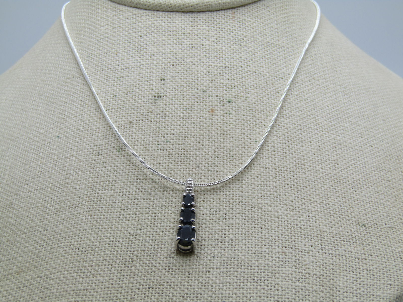 Sterling Black Spinel Pendant on 20" Plated Snake Chain: Sterling Black Spinel Pendant on 20" Plated Snake Chain. The pendant has three black spinels that are journey style with the stones being graduated from 3.5mm to 5mm to 6mm and appx. 1" long. The pend