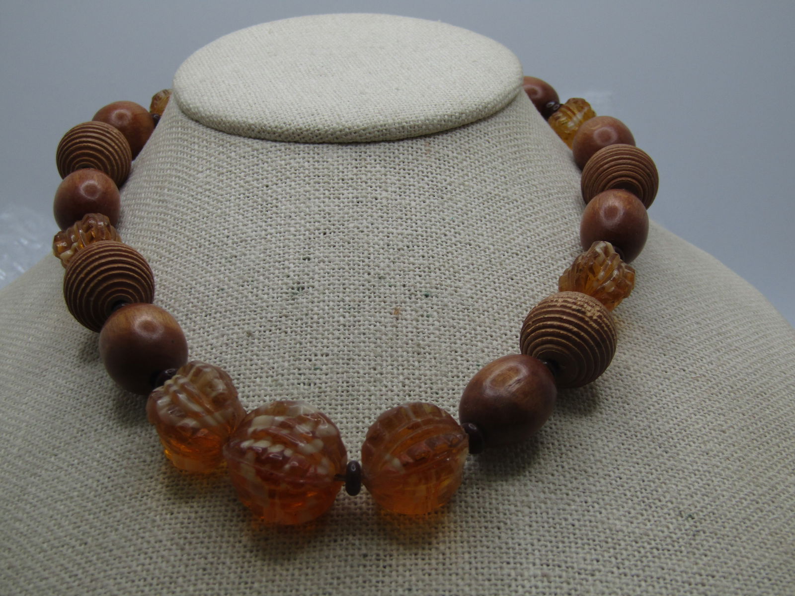 Vintage 1930's Wood & Glass Beaded Necklace, 16": Vintage 1930's Wood & Glass Beaded Necklace, 16" with a rounded brass box clasp. Thsi has smooth oval beads and rounded ridged beads with amber glass beads with white coloration in the glass beads tha