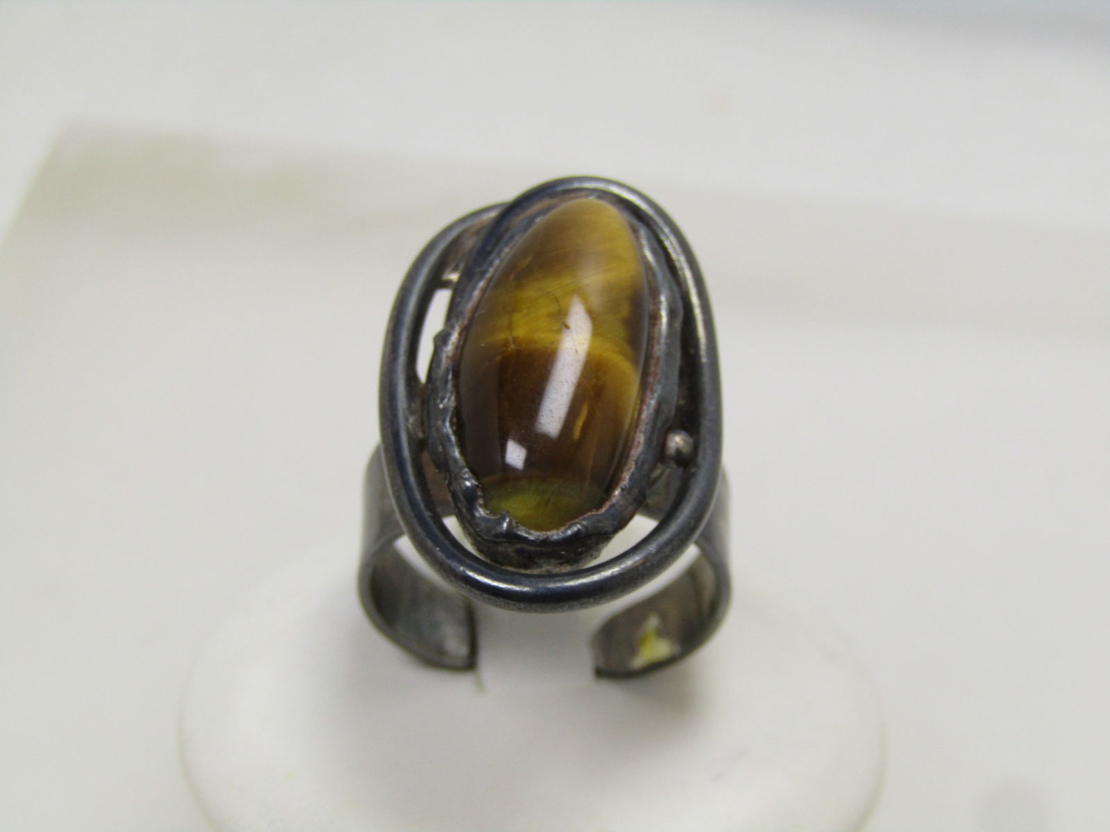 Vintage Tiger's Eye Ring, Adjustable, Sterling and Plated, Southwestern/Mod, 1970's-1980's: Vintage Tiger's Eye Ring, Adjustable, Sterling and Plated, Southwestern/Mod, 1970's-1980's. this has a elongated tiger's eye cabochon that is bezel-set in a rugged looking bezel, designed that way. 