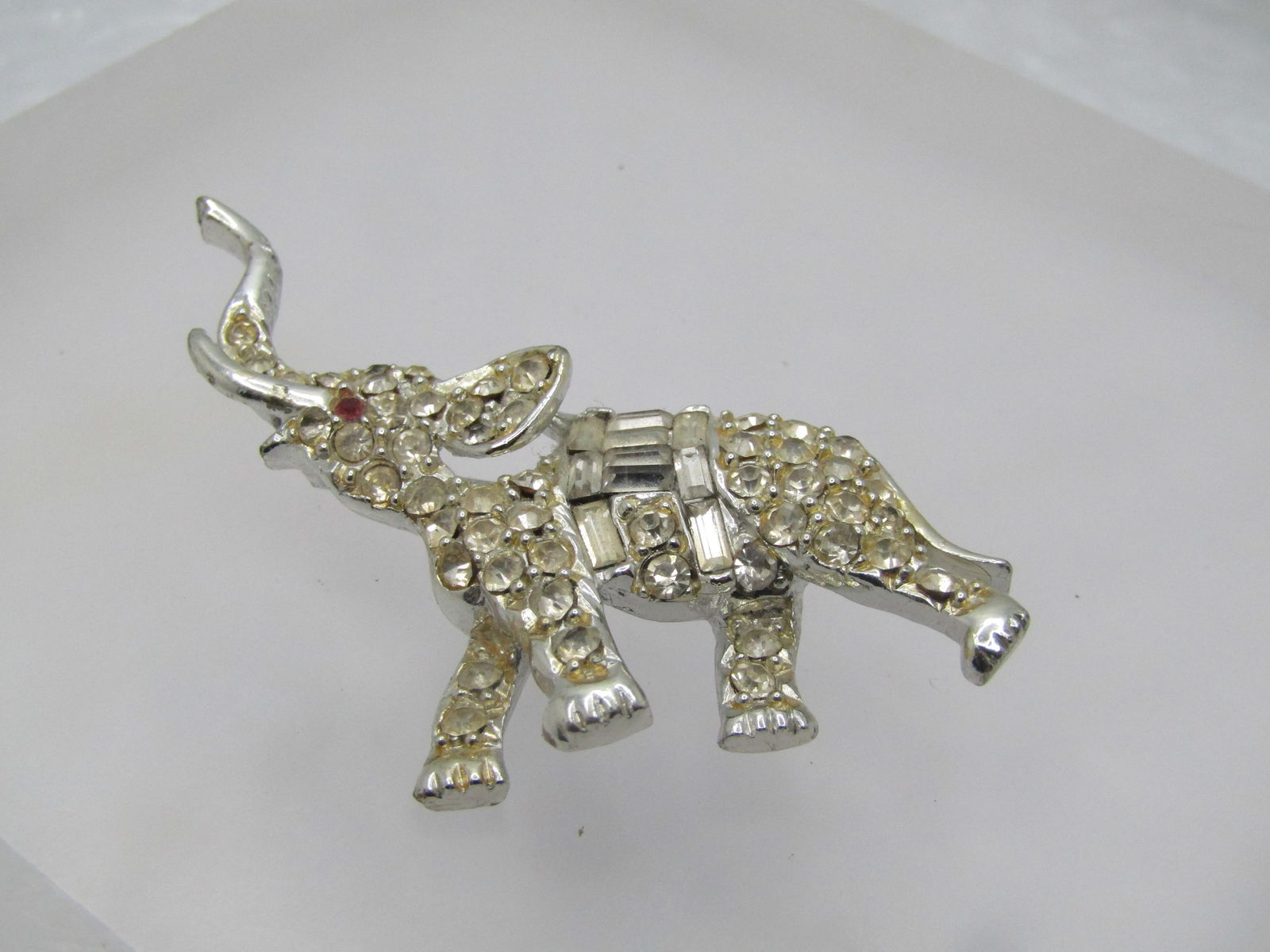 Vintage Rhinestone Elephant Brooch, 1940's-1950's, 2": Vintage Rhinestone Elephant Brooch, 1940's-1950's, 2" wide and 1.75" tall. Silver tone with round and baguette clear rhinestones and a red rhinestone eye. Very good condition, locking clasp. Not signe