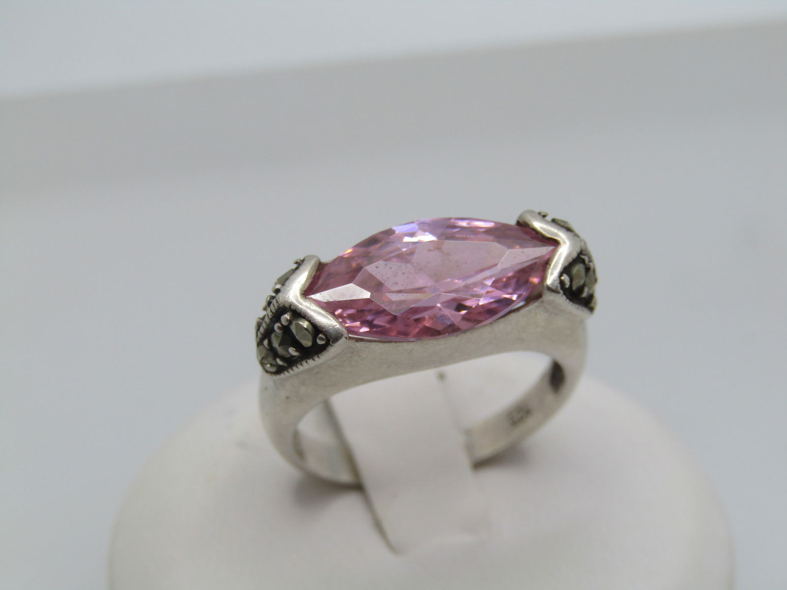 Sterling Pink CZ Marcasite Ring, Sz. 7.5.: Sterling Pink CZ Marcasite Ring, Sz. 7.5. This has an appx 15mm y 8mm marquise pink CZ stone that is set long-way across the finger with a V accent with marcasites that holds the stone in the
