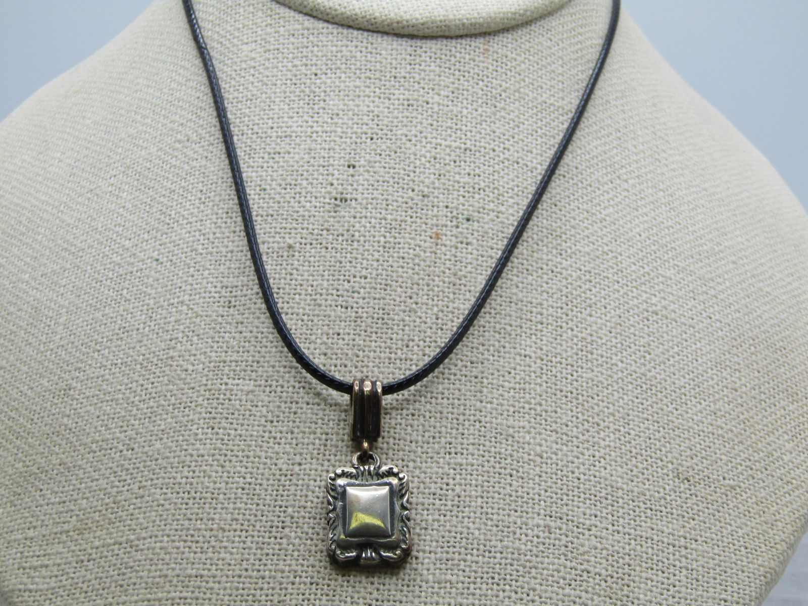 Vintage Sterling Engraveable Pendant Necklace 20": Vintage Sterling Engraveable Pendant Necklace 20". The pendant has a ridged bail from which a scrolled tiered square drop dangles with a flat center where it could be engraved by your jeweler if desir