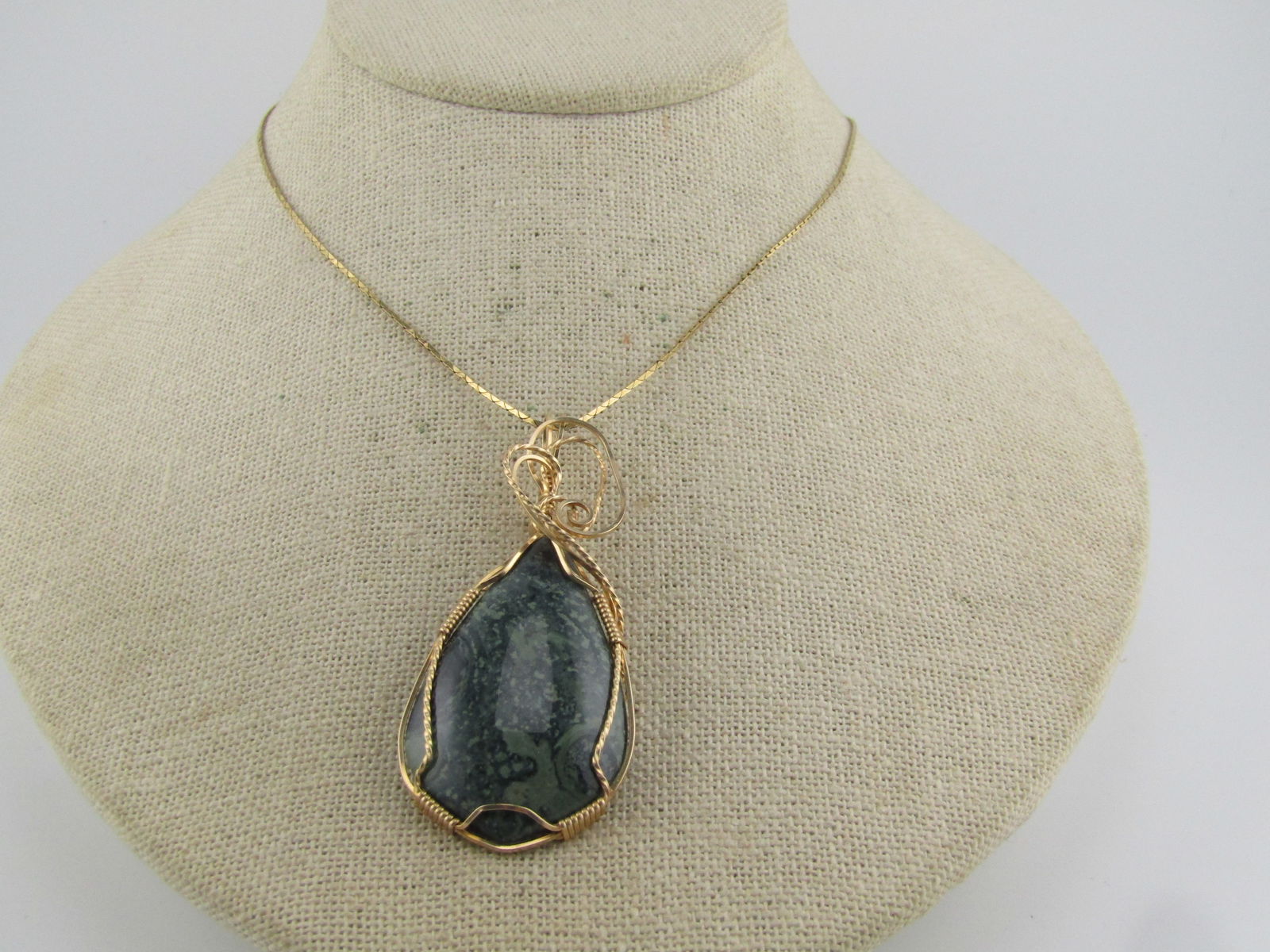 Vintage 10kt G.F. Wrapped Agate Pendant, 1980's-1990's, NO CHAIN: Vintage 10kt G.F. Wrapped Agate Pendant, 1980's-1990's, NO CHAIN. This pendant has an intricate wrapped and coiled finish on a natural green agate that is appx. 40mm by 25mm. The wire is both square a