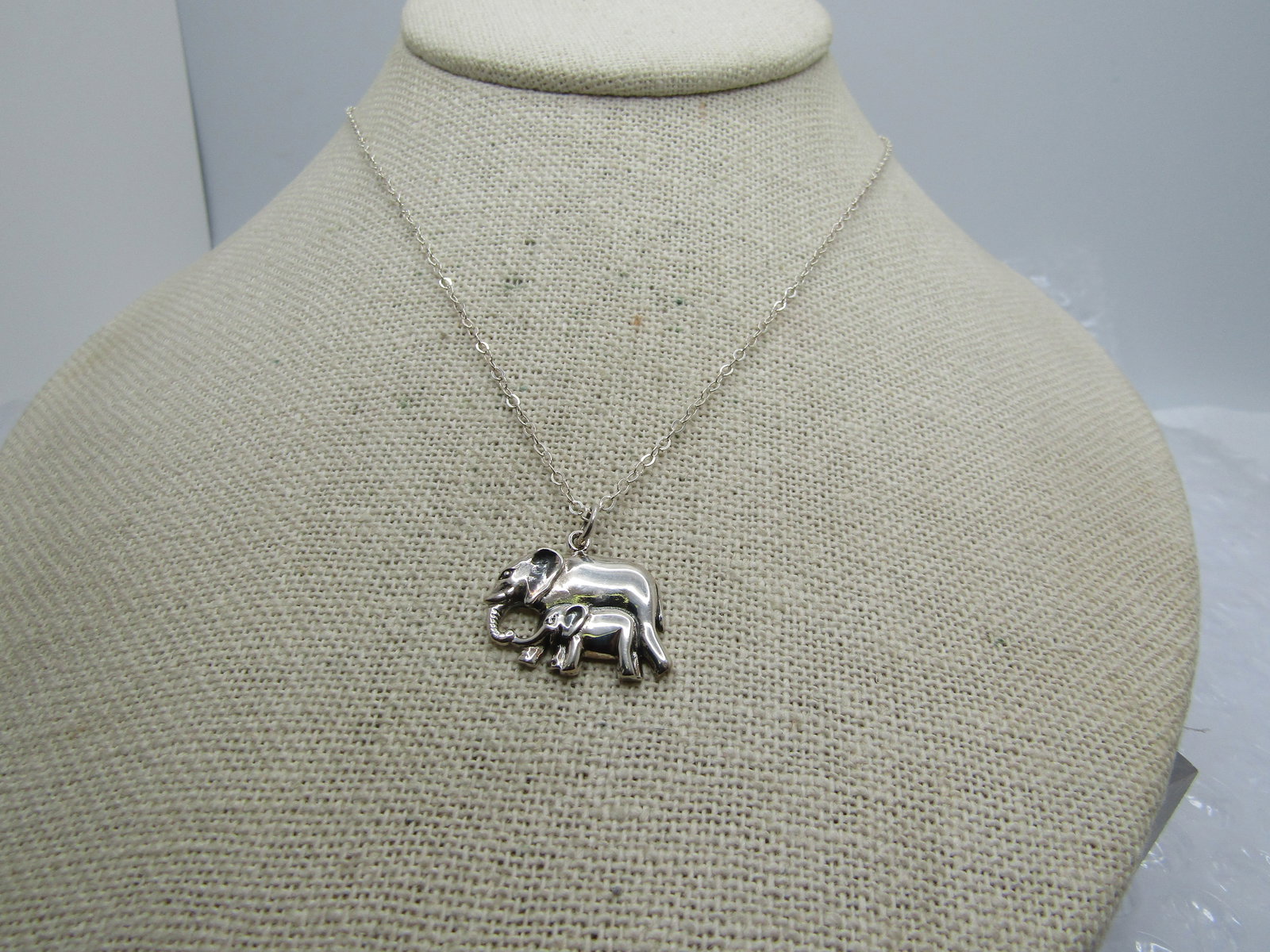 Sterling Elephants Necklace, 16"-18", Mom and Baby: Sterling Elephants Necklace, 16"-18", Mom and Baby. It is marked .925 and signed with a n. the chain is 16" with a 2" extender chain and lobster clasp. The necklace/chain test as sterling with a