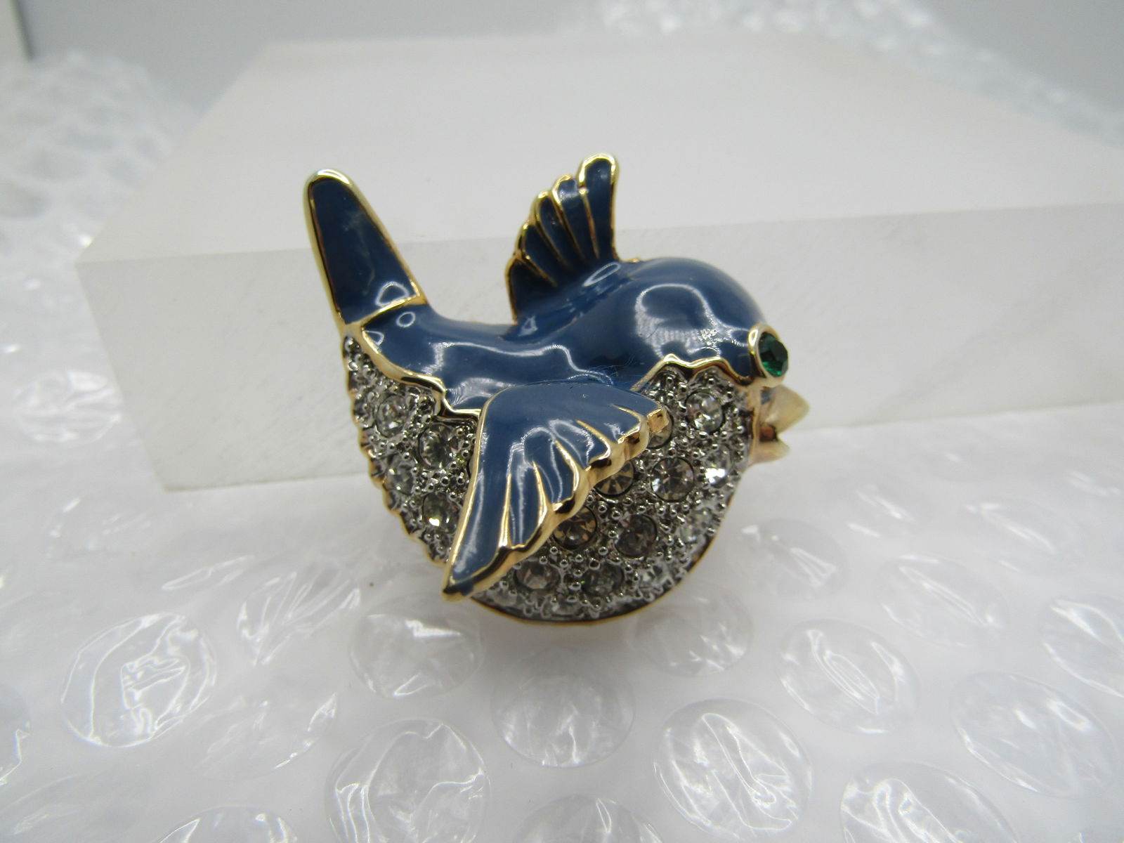 Vintage Blue Enameled & Rhinestone Trembler Bird Brooch: Vintage Blue Enameled & Rhinestone Trembler Bird Brooch. His bottom 2/3" of his body is set with clear rhinestones in a mix of sizes. His wing over those rhinestones is the trembler - the top of his b